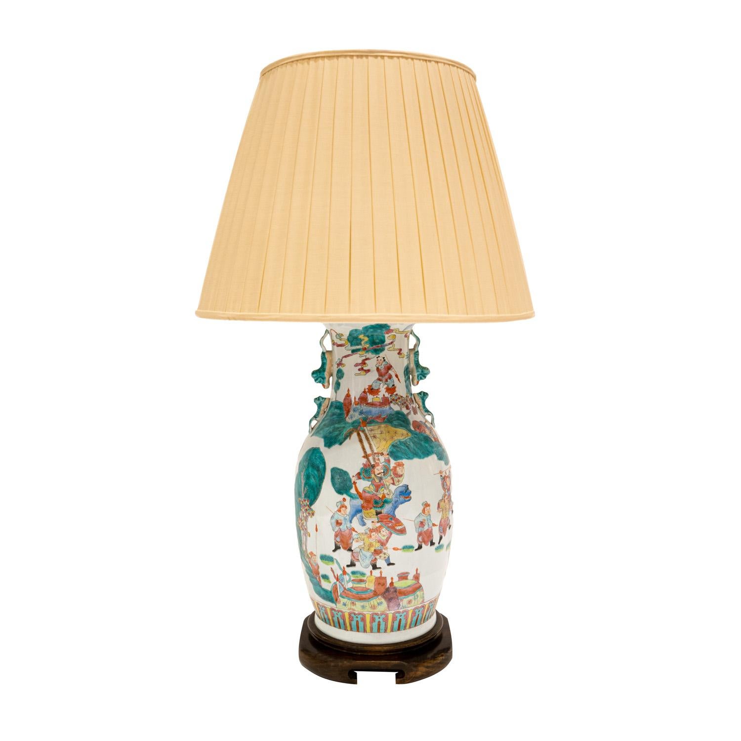 Exceptional studio made porcelain table lamp with hand-painted figural and geometric decoration on a carved wood base, China 1960's. The artisanship of this lamp is superb.  This lamp has 3 bulbs - 1 faces upward and 2 are on the sides.  It’s a