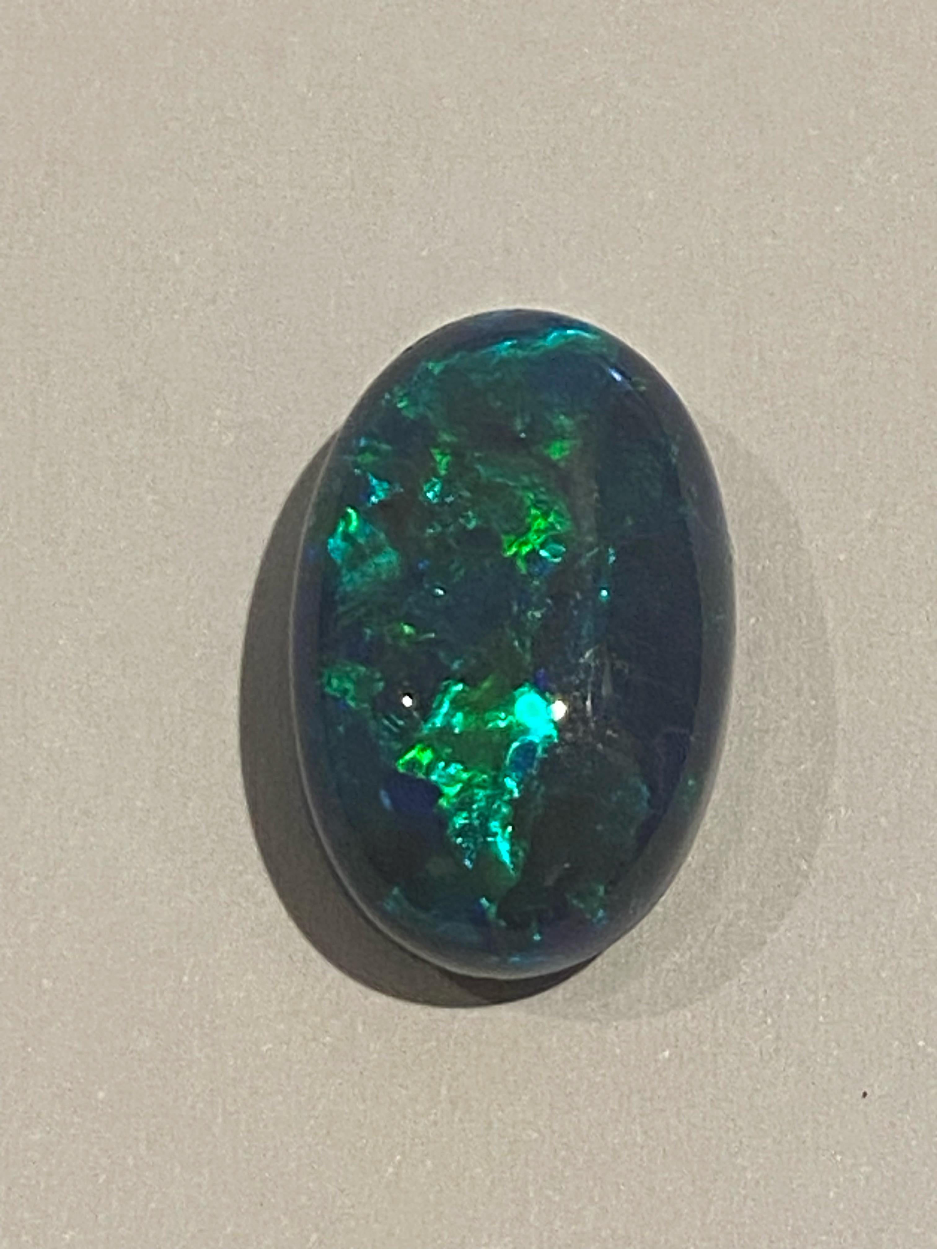 This magnificent Australian Black Opal is 
from Lightning Ridge, NSW 

It's of impressive & rarely encountered size:
9.20ct (17.13mm x 11.36mm x 7.41mm)

It's Natural, of type 1, 
meaning that it hasn't been treated or enhanced &
that it's solid