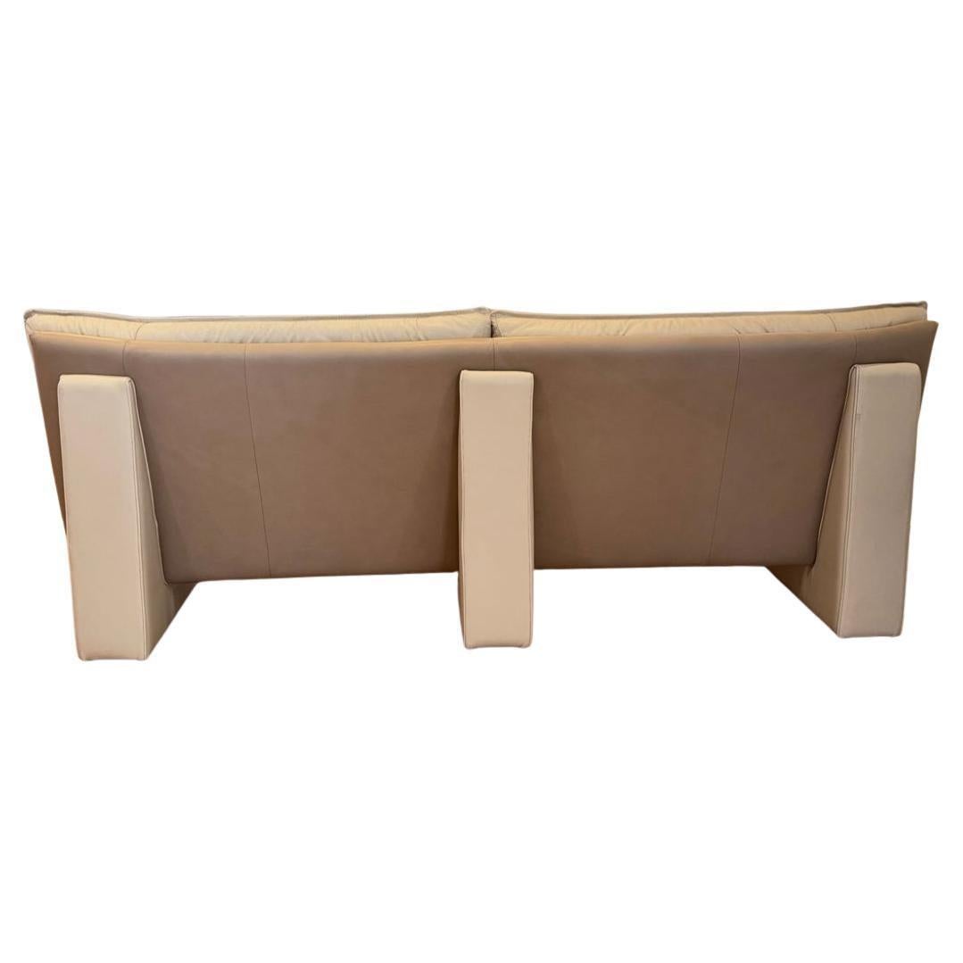 Beige and tan Nicoletti Salotti Post Modern Italian Leather Sofa. Very fun Beautiful pop art long leather sofa. Has unique back supports and legs upholstered in leather. Very good vintage condition will transform any post modern or modern designed