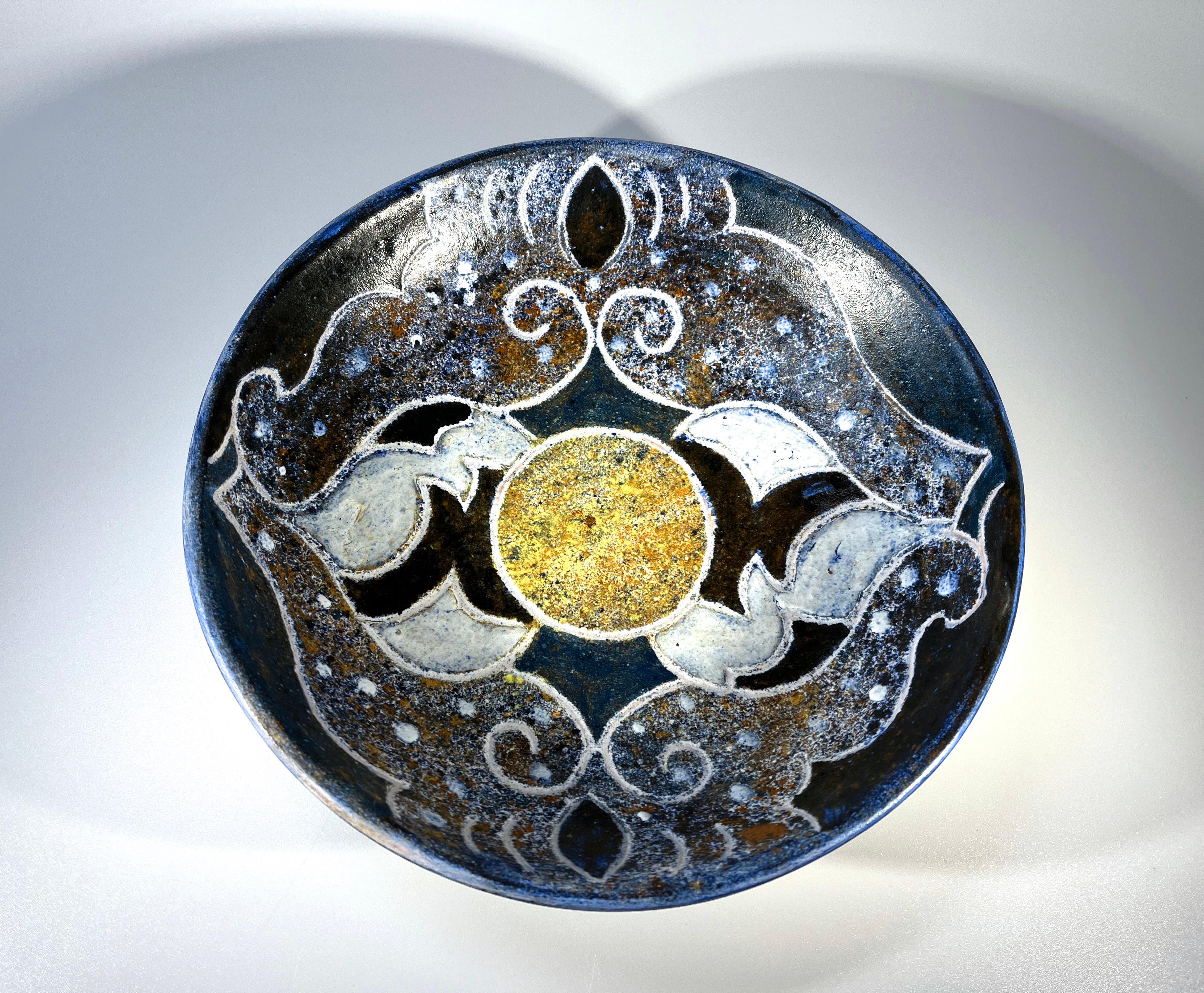 A superbly glazed dish with stylised motifs, created by renowned ceramicist Bernard Buffat for La Grange Aux Potiers, France
Shades of blue, black white and gold decorate
Circa 1970
Signed Piece Unique and initials
Height 2 inch, Diameter 8 inch
In