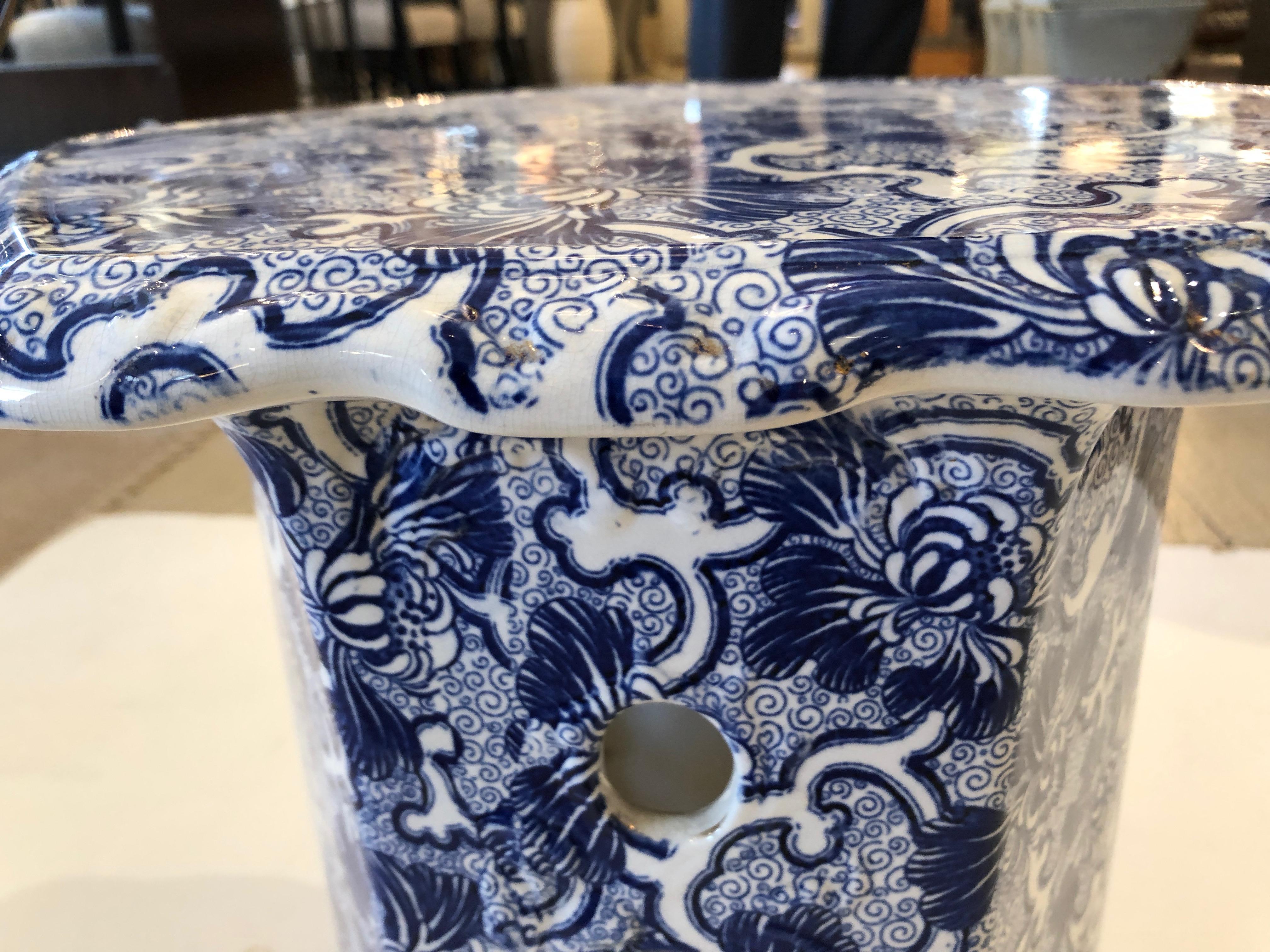 A gem of an antique 19th century English garden seat having 6 sides that are scallopped on the edges. The pattern is an intricate gorgeous blue and white and there are pretty openings on the sides of the table. Makes a superb drinks table or little