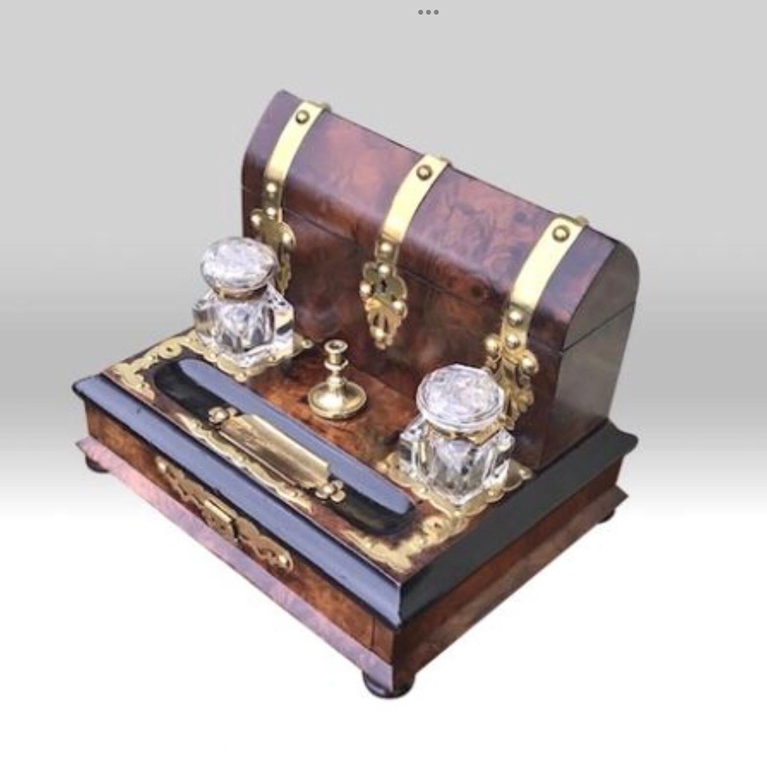 Stunning brass bound burr walnut antique letter writing box
Complete with ink wells, wax seal candle stick, letter compartment and drawer.
Working lock and key.
Dated 1872
Measures: 12ins x 10ins x 10ins
£1250.
   