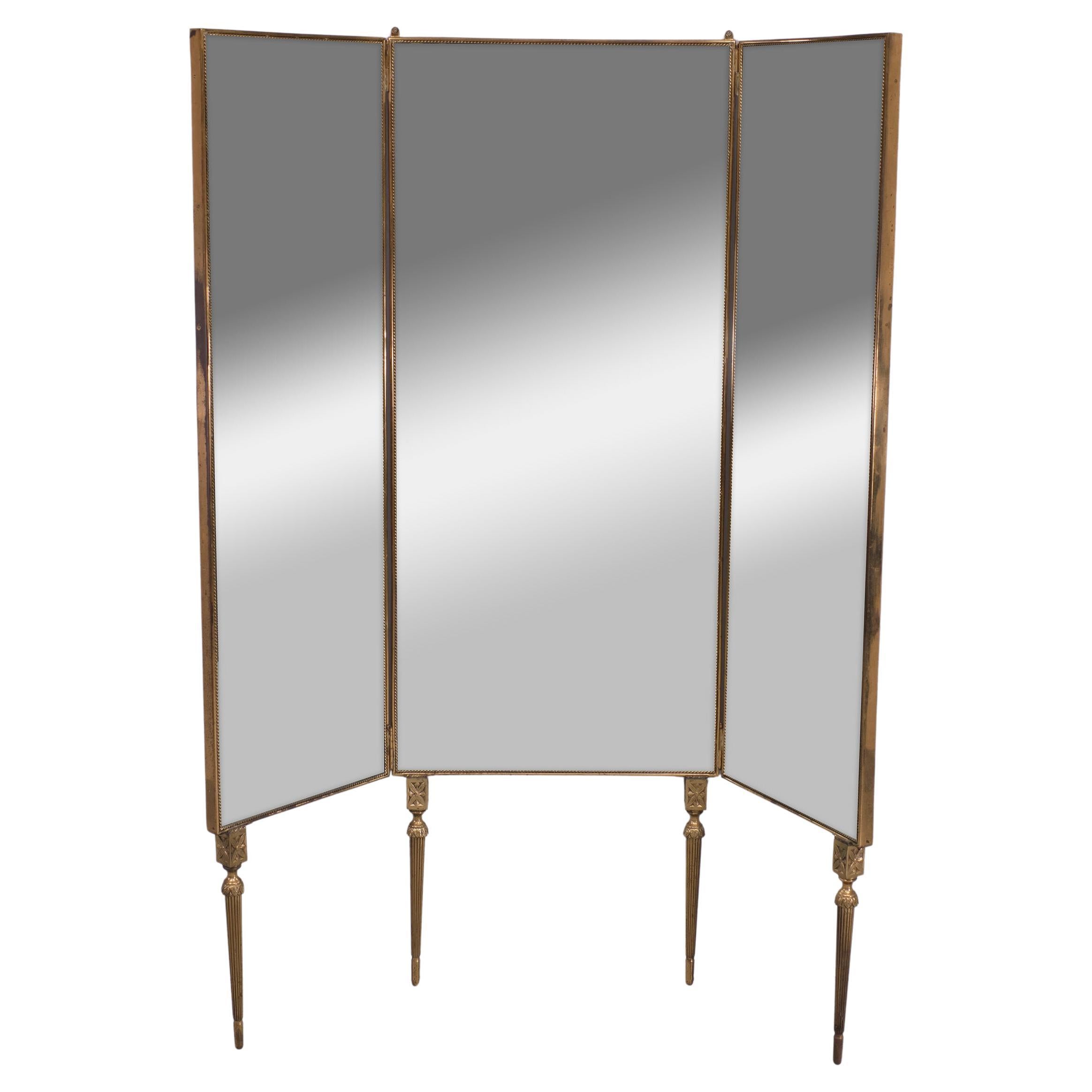 Superb full length folding mirror .Brass frame en legs .The middle section 
attached to the Wall . The side panels are moveable sideways  so you can 
see your side and back, ideal for the real fashionata . Very good quality .
Comes with solid brass