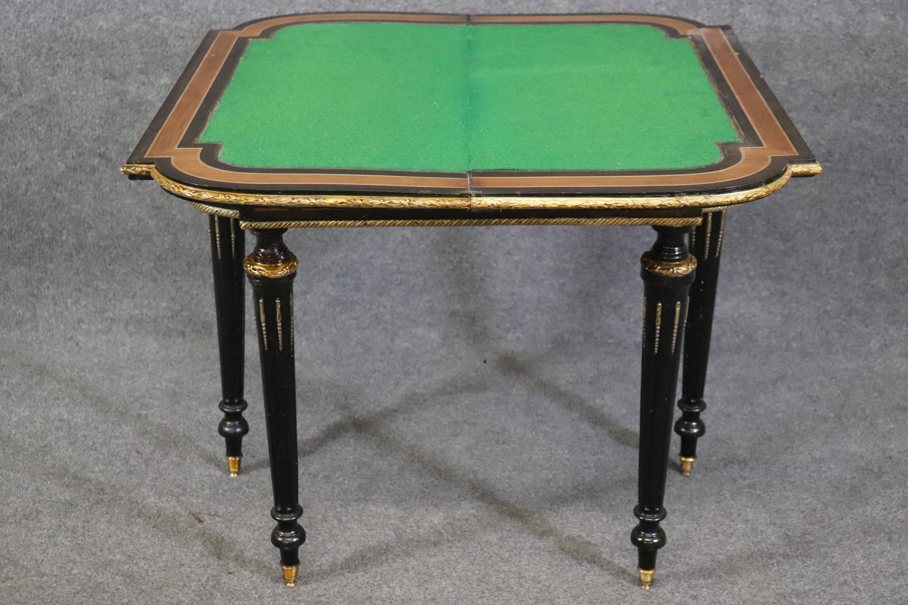 If you're going to be playing cards, playing chess or any other game with your friends or family-it might as well be in style! This is a beautifully inlaid French games table featuring inlay of birds and foliage in walnut and a gorgeous ebonized