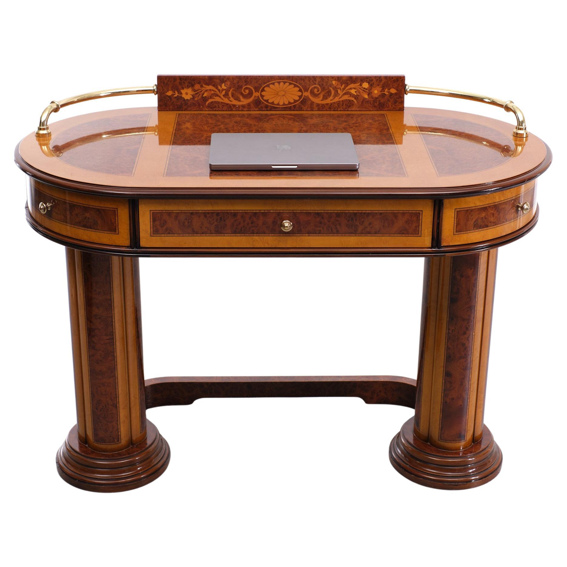 Beautiful oval shaped ladies desk. Burl wood, comes with all kind off different Fruit wood inlay High gloss finish. Stands on Columns. Three drawers 
Two on the rounding and one in the middle. Brass details. Well made furniture.
makers piece.
