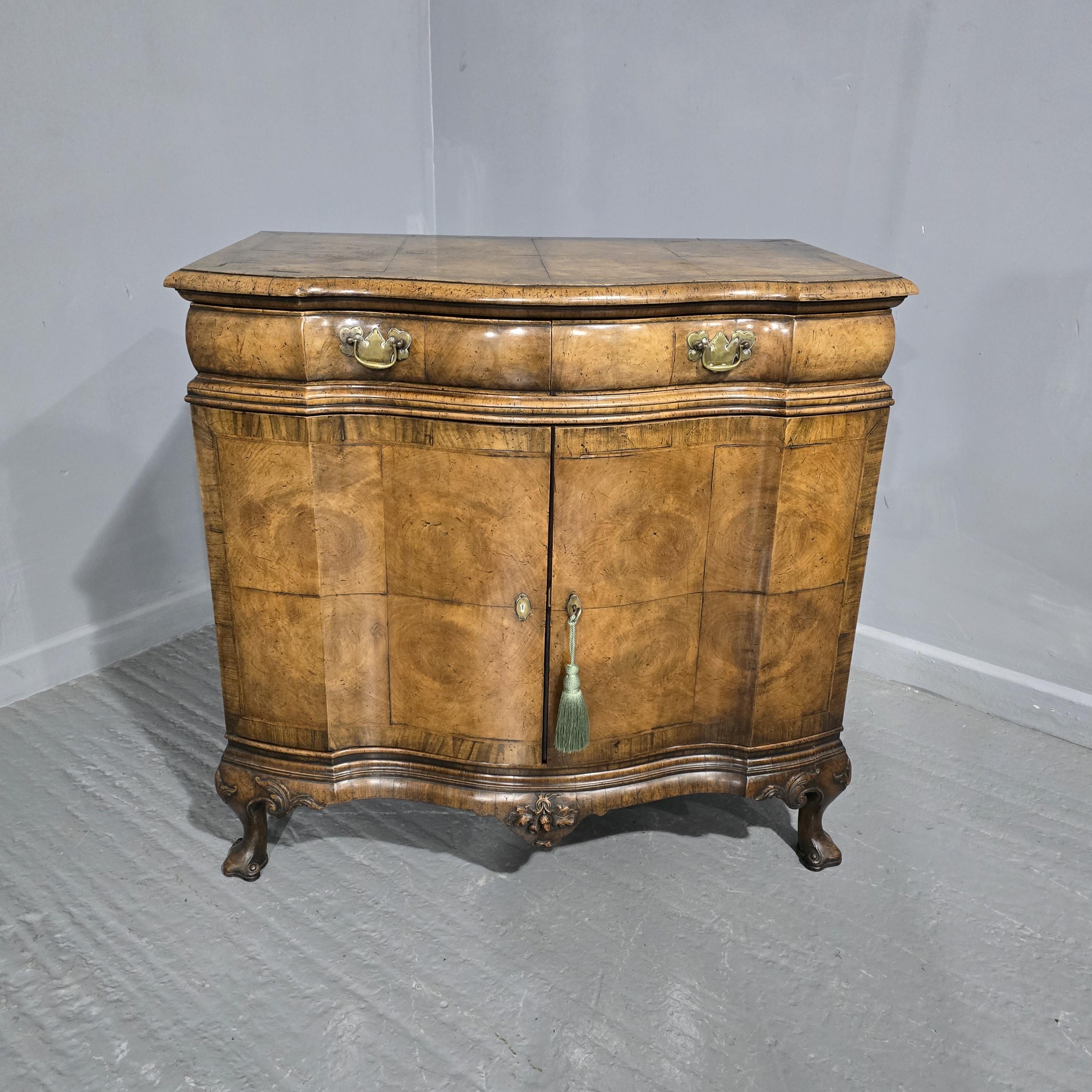 Superb quality burr walnut bowed side cabinet or commode, in the Queen Anne style, double bowed doors, two cushion drawers with brass handles, made by 'Charles Tozer'London, excellent colour.

35
