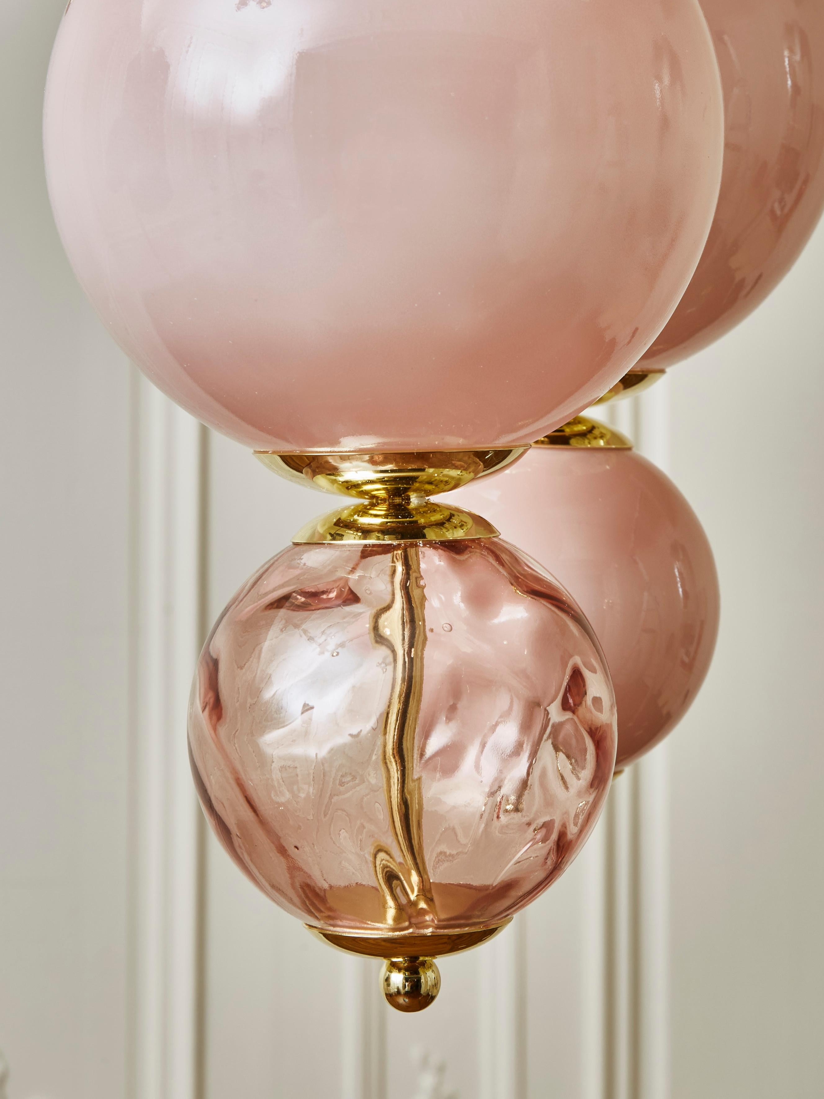 Superb suspensions in gilt metal, pink opaline glass and pink blown Murano glass globes.
Creation by Studio Glustin.