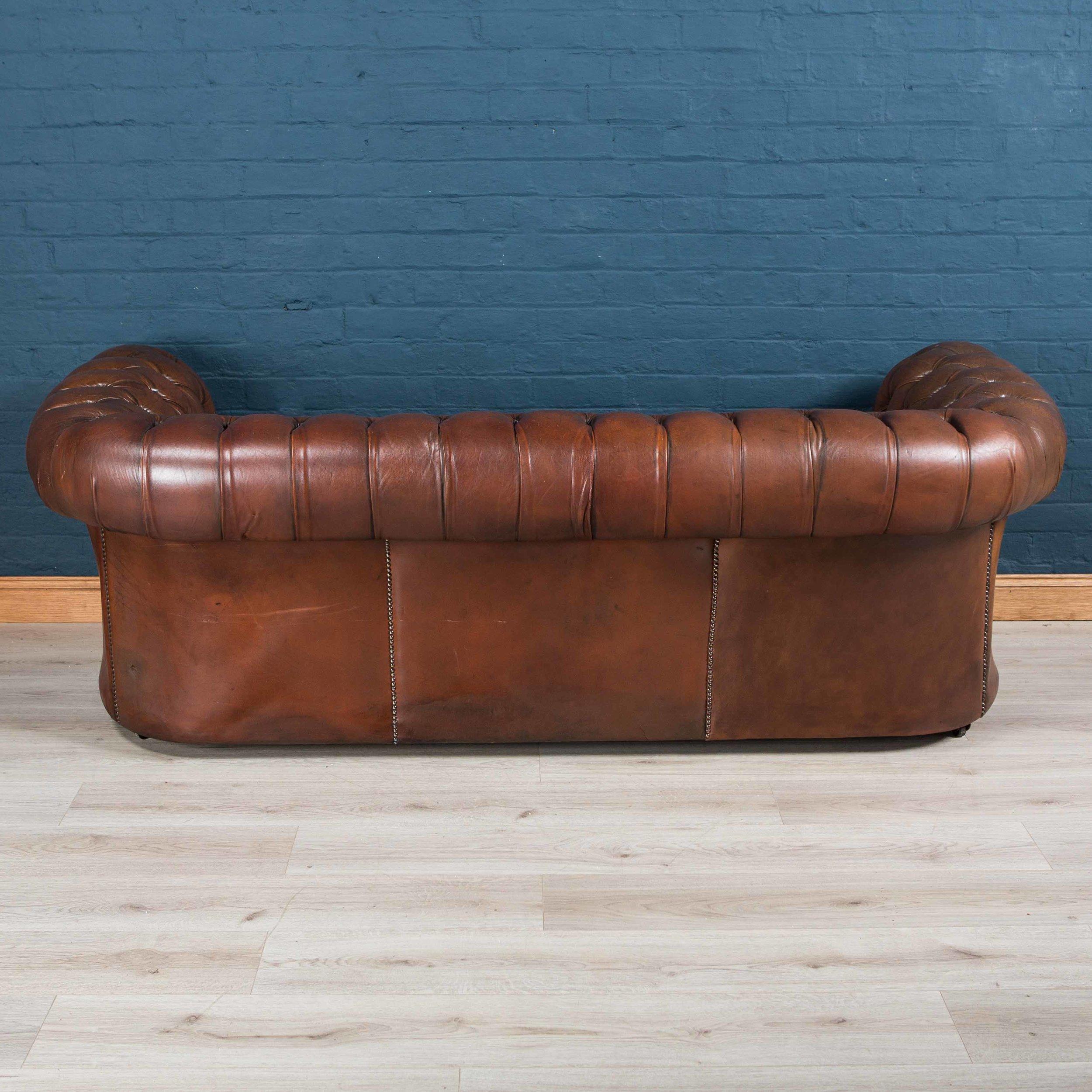 Superb early to mid-20th century leather Chesterfield sofa. One of the most elegant models with button down seating, this is a fashionable evergreen capable of uplifting the interior space of any contemporary or traditional home, the Classic color