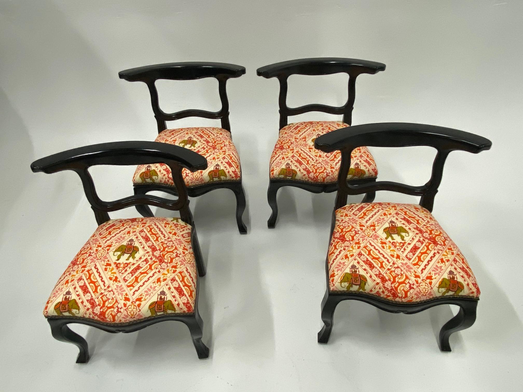 Very chic set of 4 ebonized Hollywood Regency slipper chairs having an oriental stylized silhouette, cabriole legs, and fabulous new elephant motif upholstery. Beautiful from every angle.