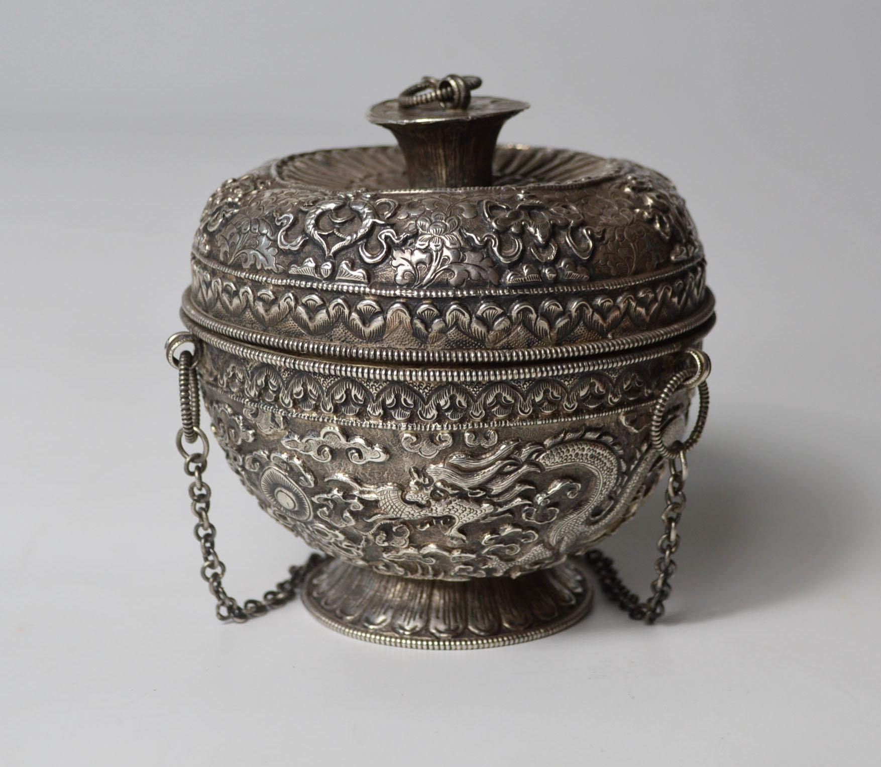 Superb rare Chinese/Sino Tibetan Silver Altar vessel
Stunning silver altar vessel the footed bowl with lidded top and hanging chain 
Decorated all over with intricate and masterful repousse and chased designs embellished dragon floral cloud and
