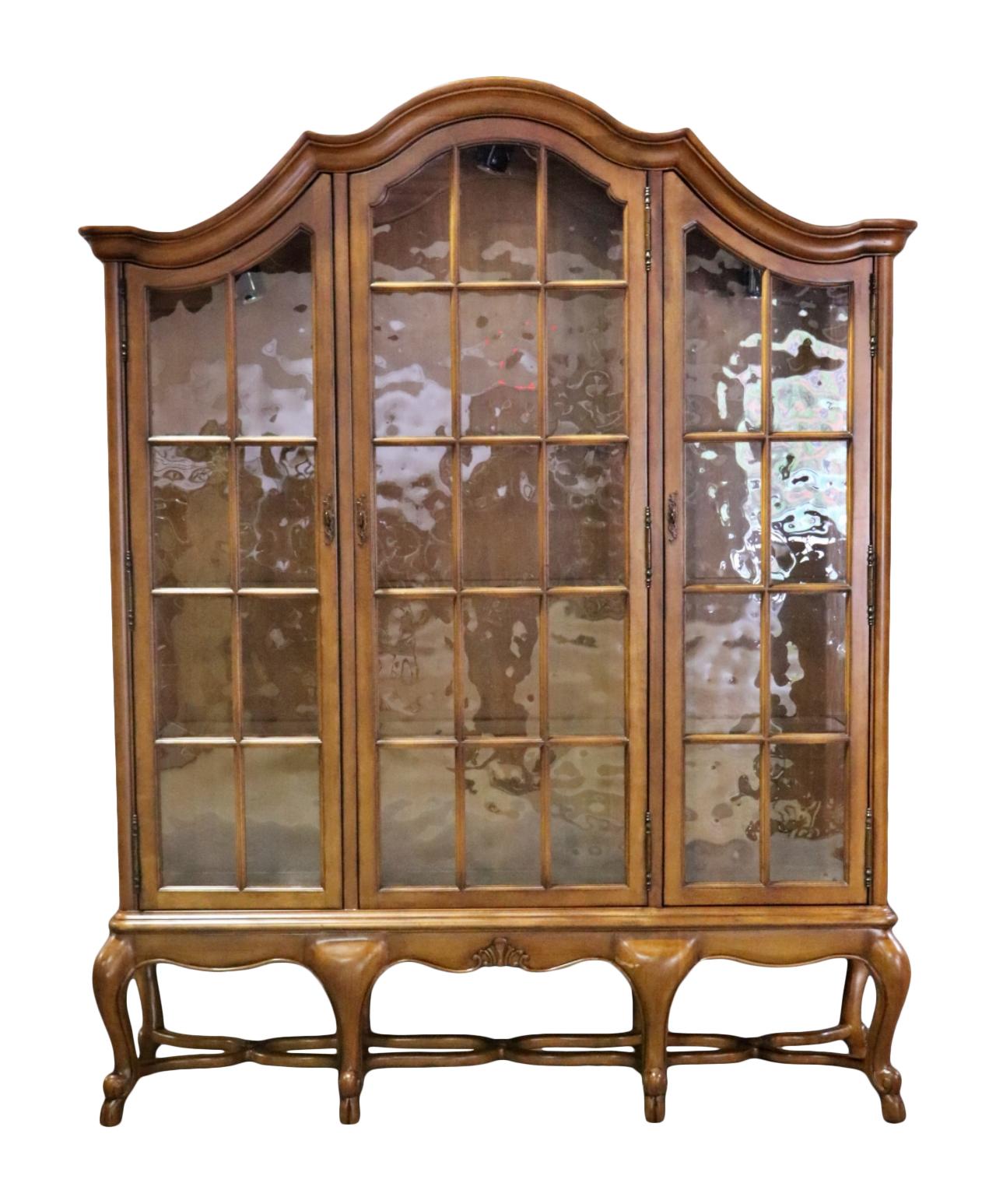 3 doors with antique wavy glass style panels. 9 glass shelves. 92