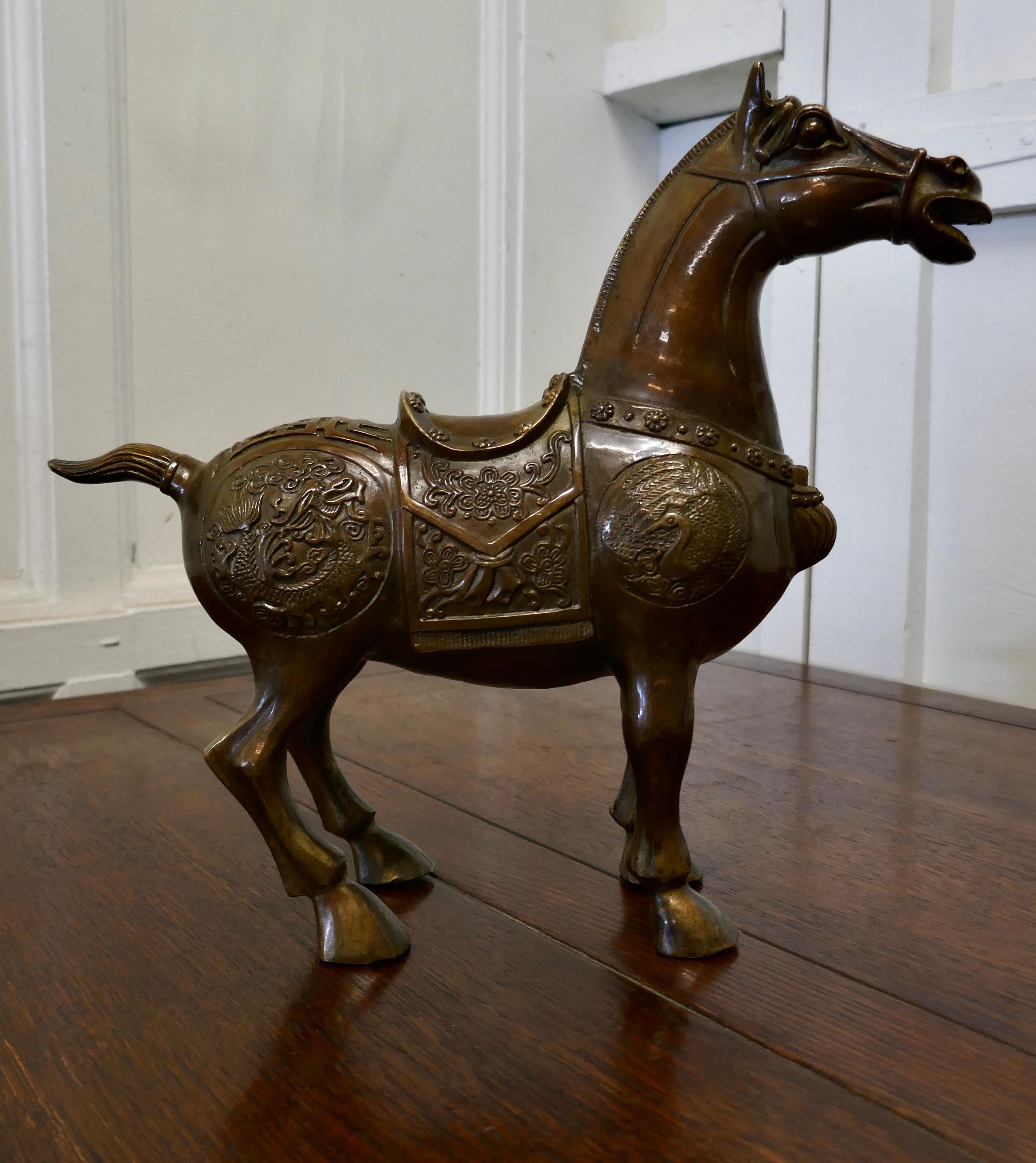 Superb decorated bronze tang horse

This is a superb piece of Chinese Folk Art, superbly cast in bronze, in the classic posed statue of this famous creature 
This is a fine piece, intricately decorated in his full costume, wearing a ceremonial