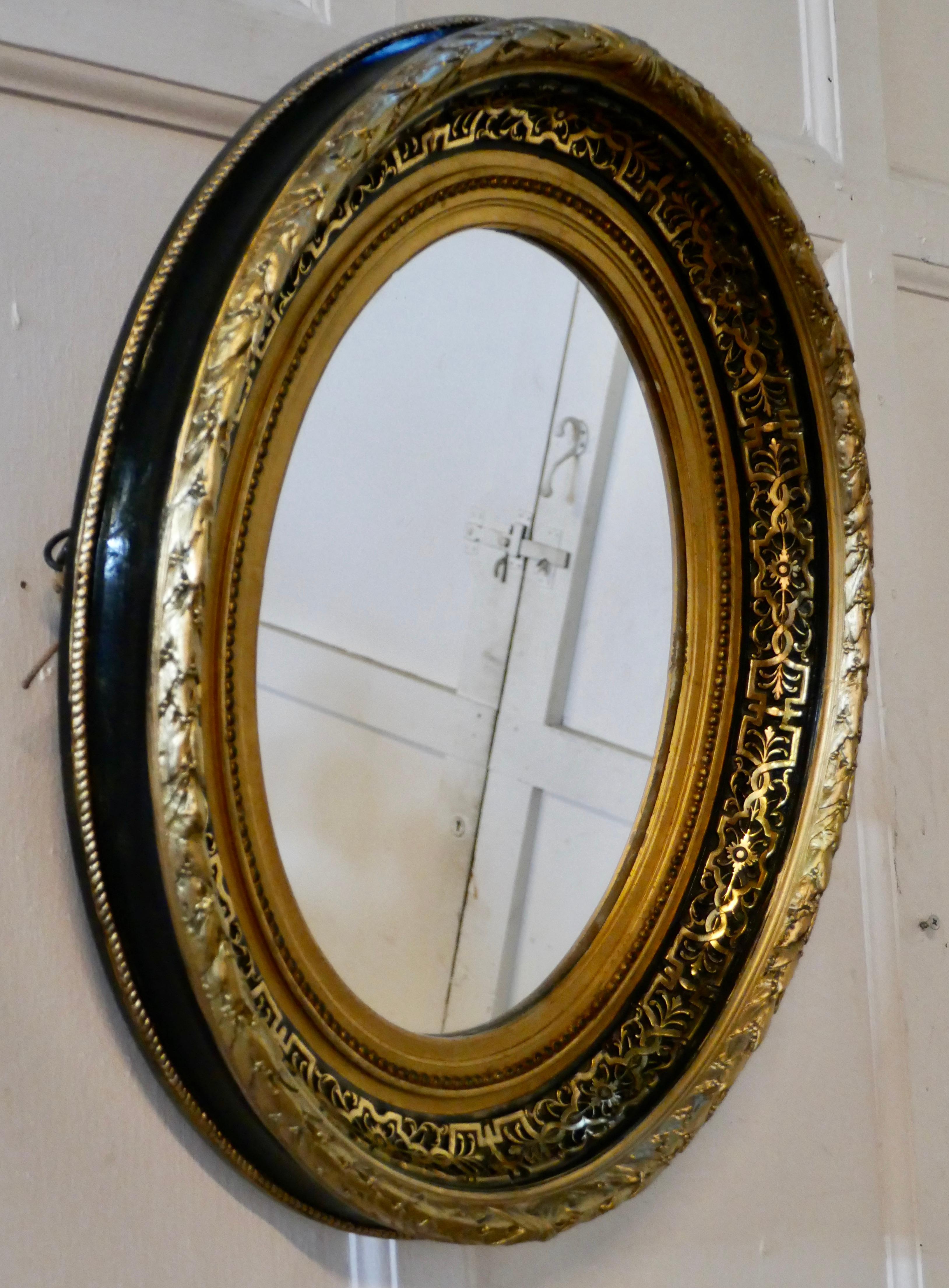 Superb deep oval frame French Empire gilt and lacquer wall mirror

This is a stunning French Empire gilt and lacquer wall mirror
The 4” oval frame is profusely decorated in black lacquer, gold gesso and gold leaf
This is a very lovely piece and