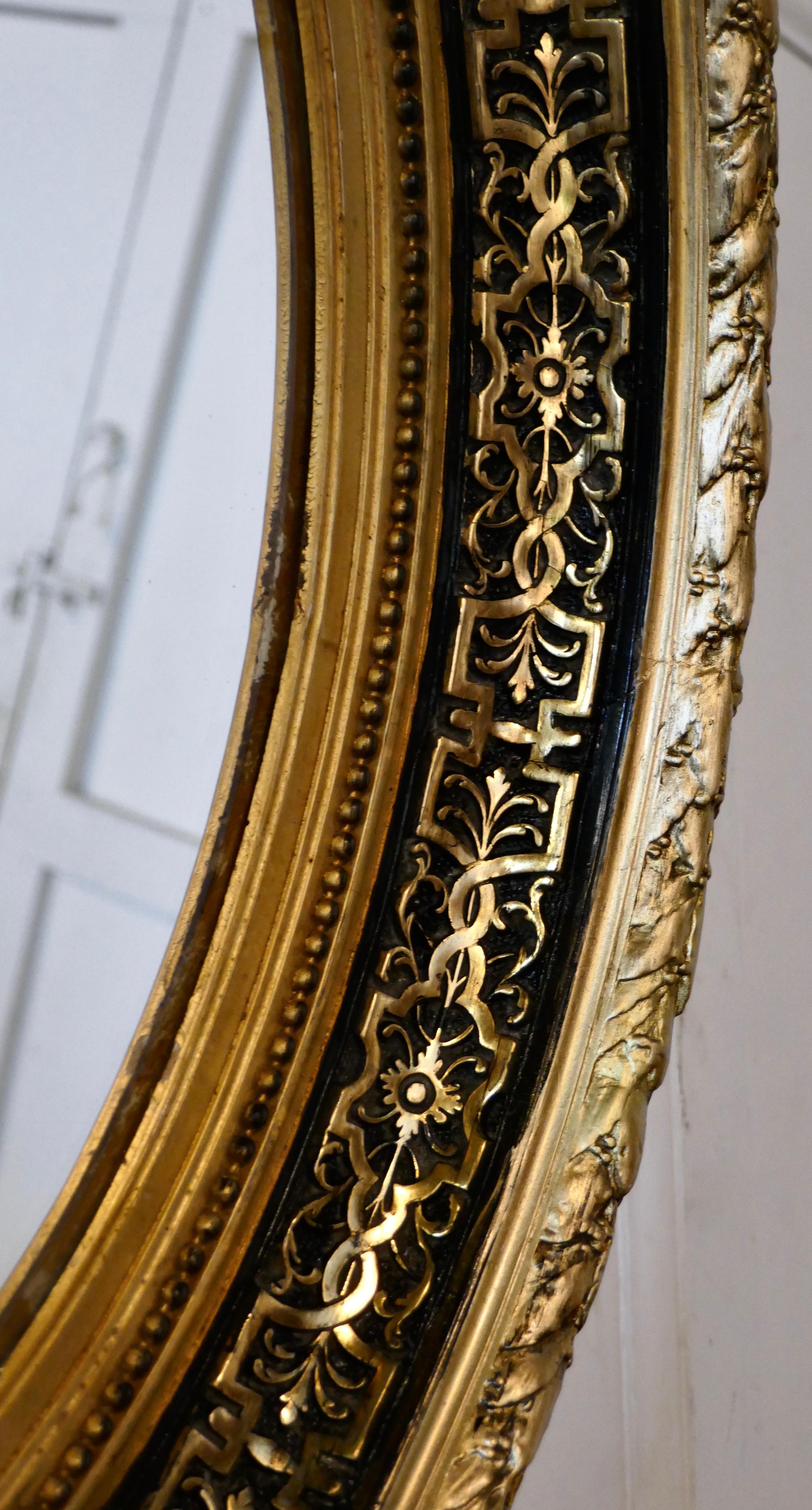 French Provincial Superb Deep Oval Frame French Empire Gilt and Lacquer Wall Mirror