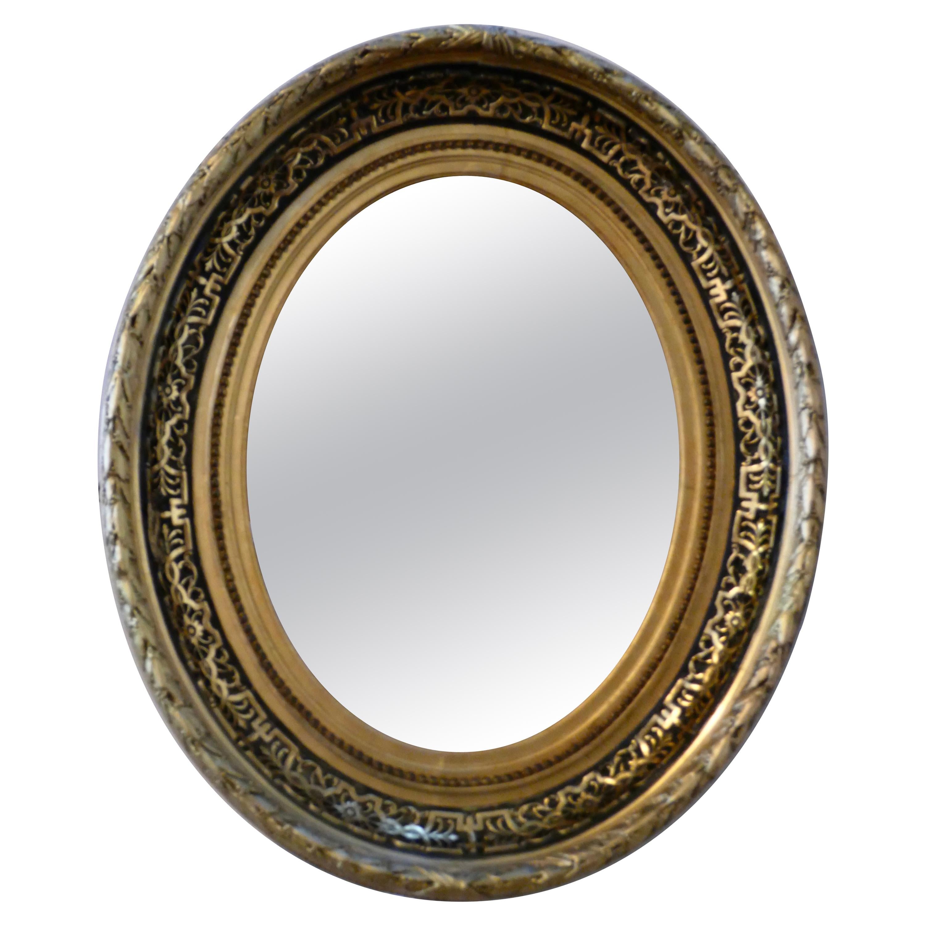 Superb Deep Oval Frame French Empire Gilt and Lacquer Wall Mirror