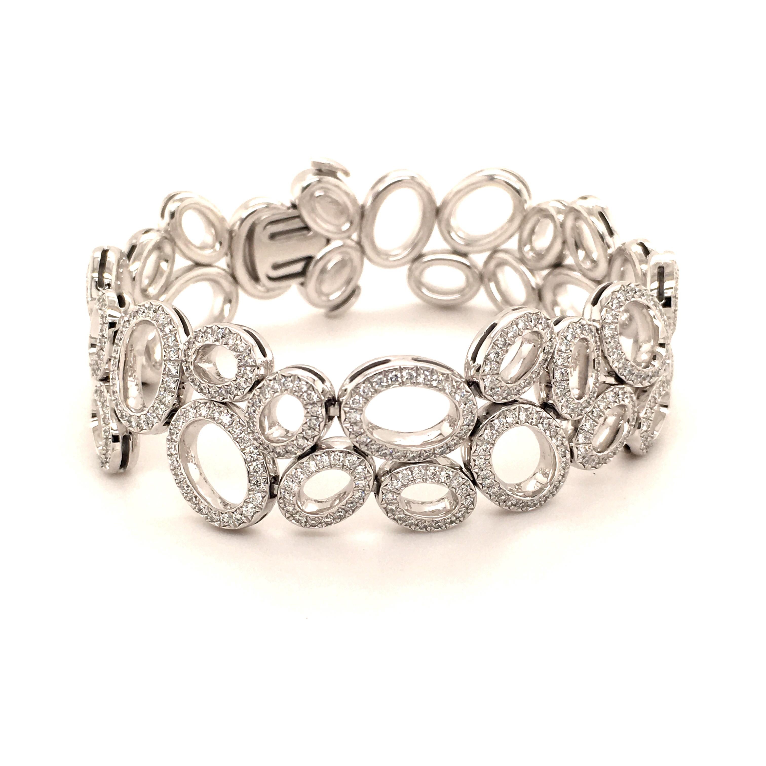This very fine and flexible diamond bracelt by Swiss Jeweller Gübelin is part of their Madagascar line.

Designed as 34 oval elements each movable and fully set with round brilliant-cut diamonds of F/G-vs quality. 628 round diamonds of very fine