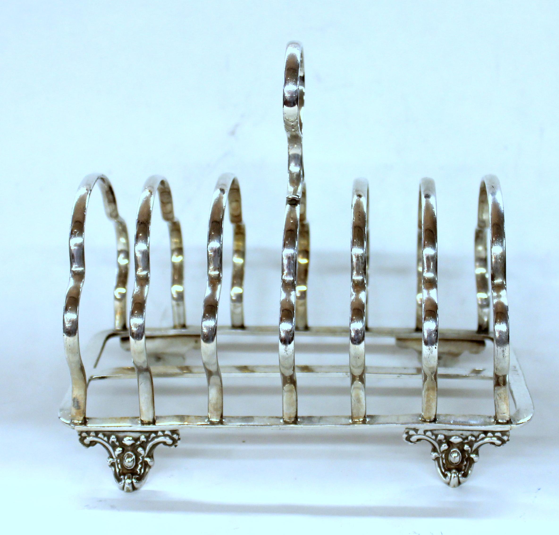 Fine Quality seven-bar toast or letter rack on lovely cast feet
Maker's marks for illustrious silversmiths, Harrison Bros. and Howson
-Sheffield-.
 