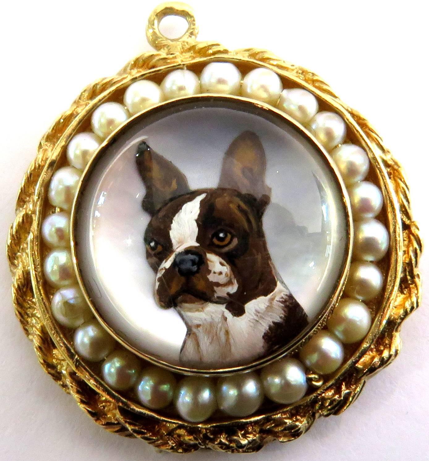 This incredibly detailed pendant charm really captures the essence of this adorable dog! The reverse crystal is deeply carved and amazingly painted. He is framed by a row of cultured pearls and then a rope design around that. 
This charm pendant
