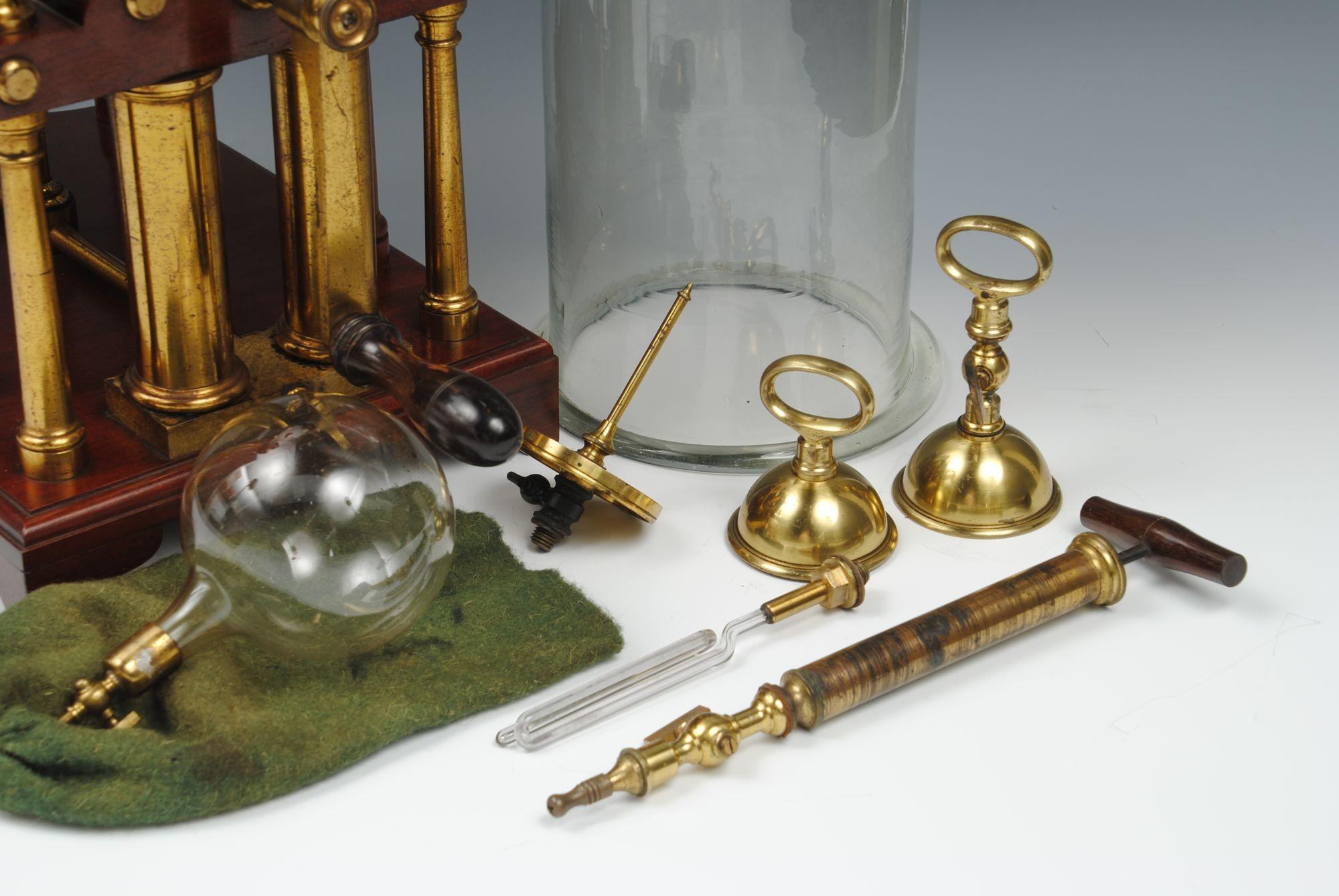 A wonderful example of a double valve demonstration vacuum pump with brass and mahogany columns, decorative finials, and the raised larger plate supported columns, with a smaller one to the rear, signed on the engraved plate by Ladd, Penton place,