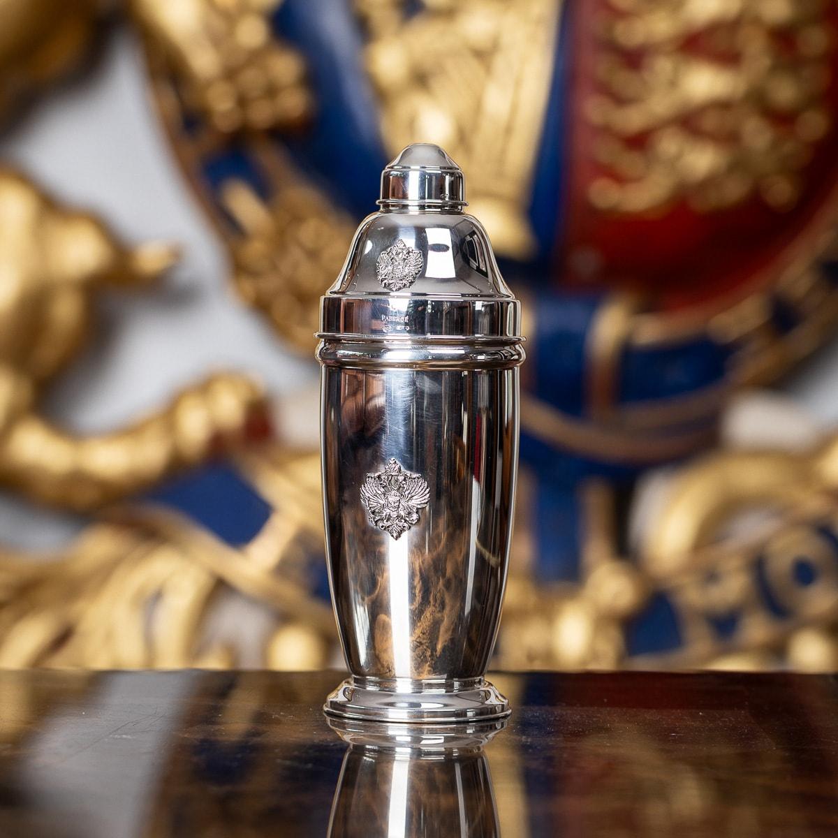 A superb Fabergé sterling cocktail shaker, featuring a polished, round, tapered body on a flared base. Both on the lid and shaker body have the Romanov eagle crest displayed in high relief. Hallmarked FABERGÉ, Italian Silver, 925 sterling silver,