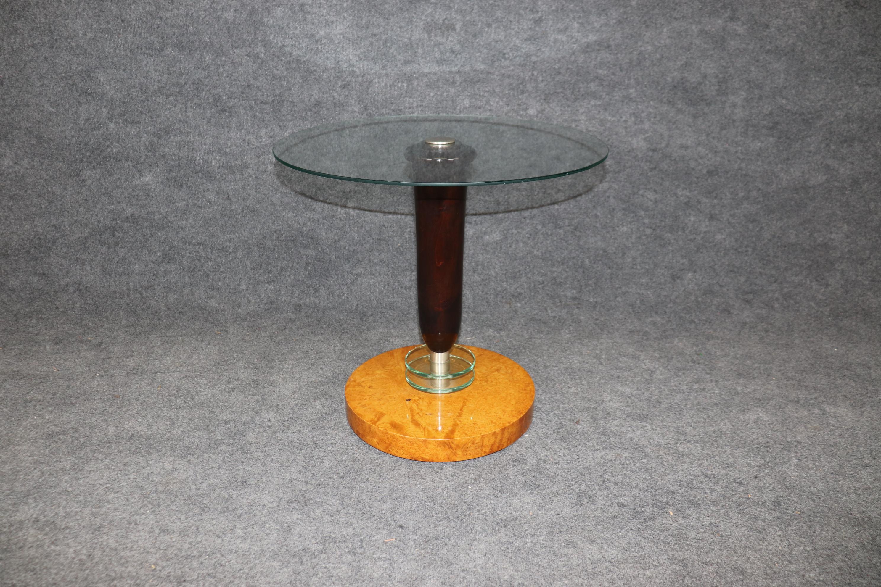 This is a fantastic machine-age style or Art deco style French-made end table. The table features superb polished birch and mahogany with the stylistic use of glass at the base and a gorgeous glass top with steel center. The table is a custom-made