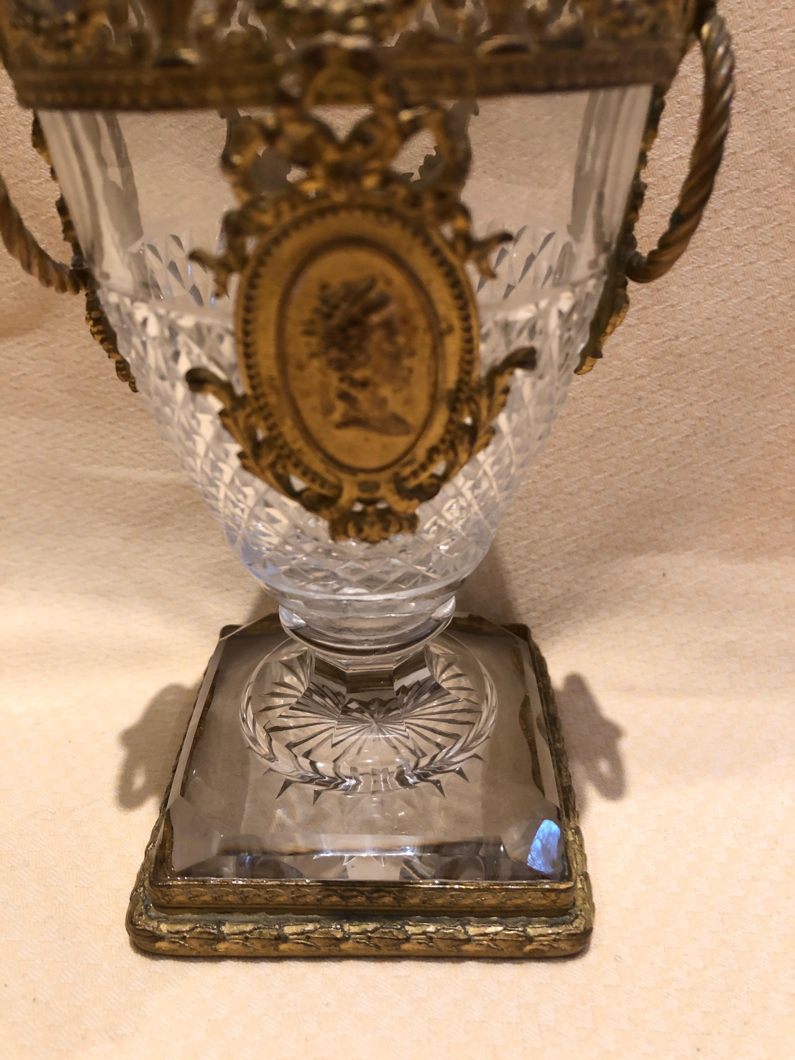 A magnificent small cut crystal vase having ornate ormolu mountings with swag and central cameo as well as side rings.