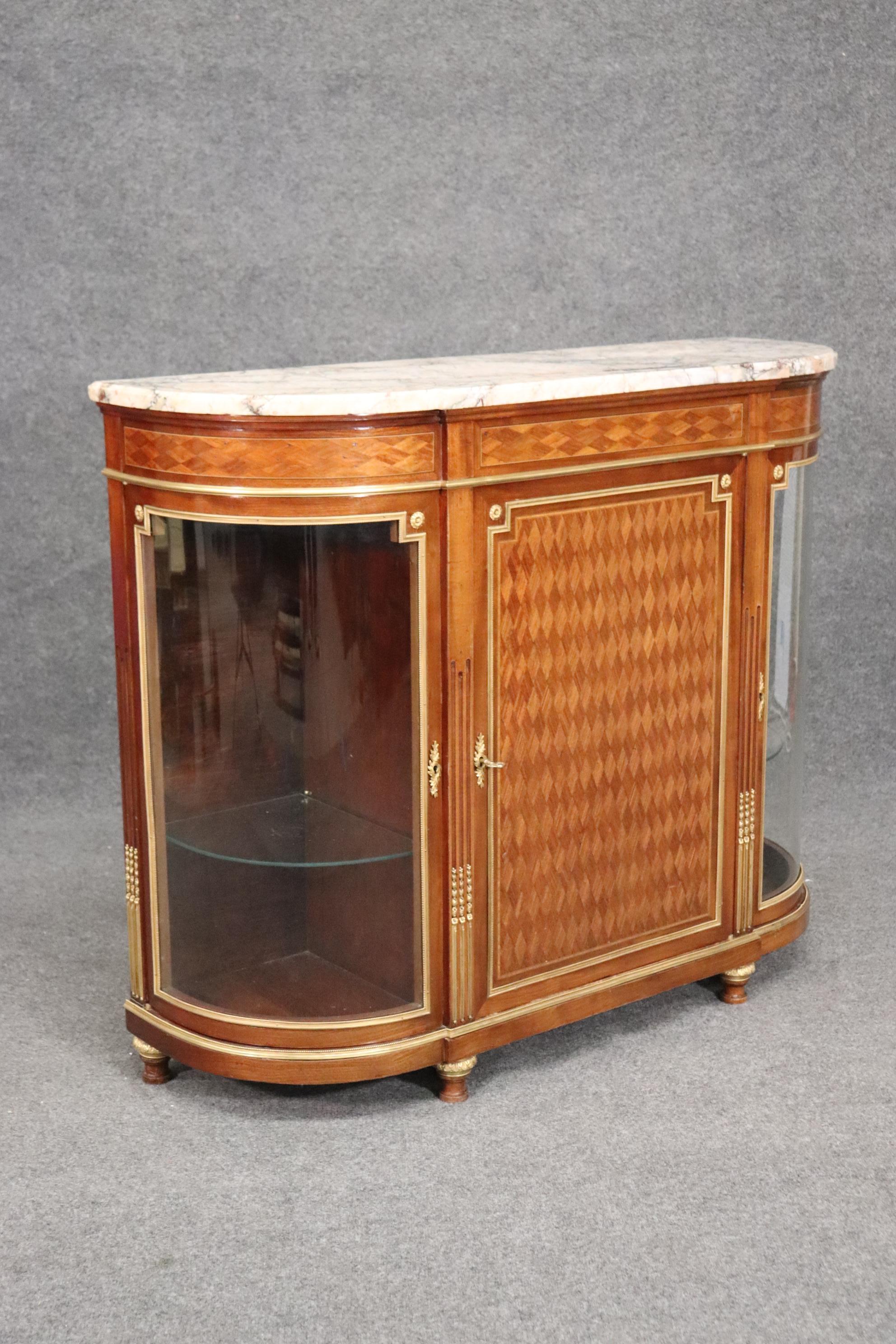 This is a stunning and extremely well executed French sideboard with gold dor'e bronze mounts and elaborate kingwood marqetry. The sideboard is a perfect size for a room that needs a shallow piece that doesn't take up much depth of the floor. The