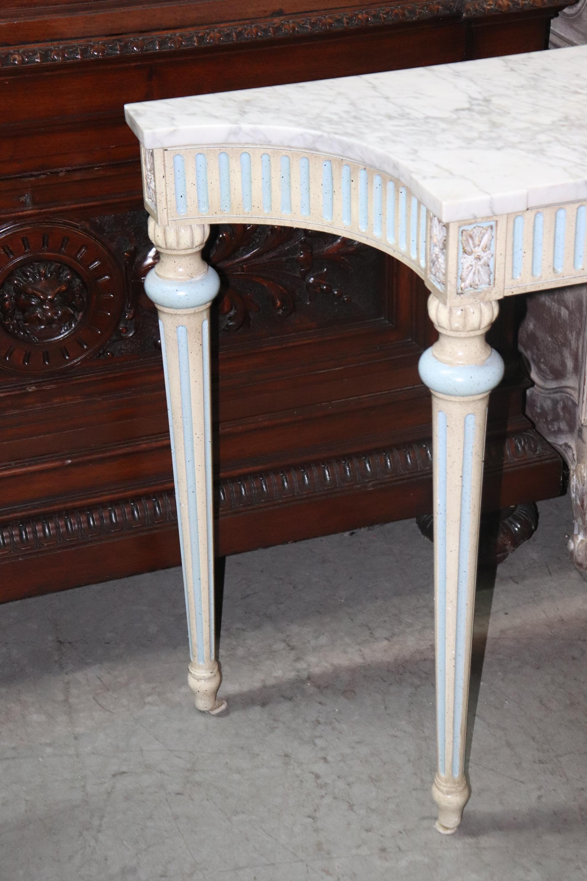 This is a superb American made French louis XVI style console table. The beautiful marble top is in very good condition and the frame is beautifully painted in white and blue. The table measures 61 wide x 16 deep x 32 tall.