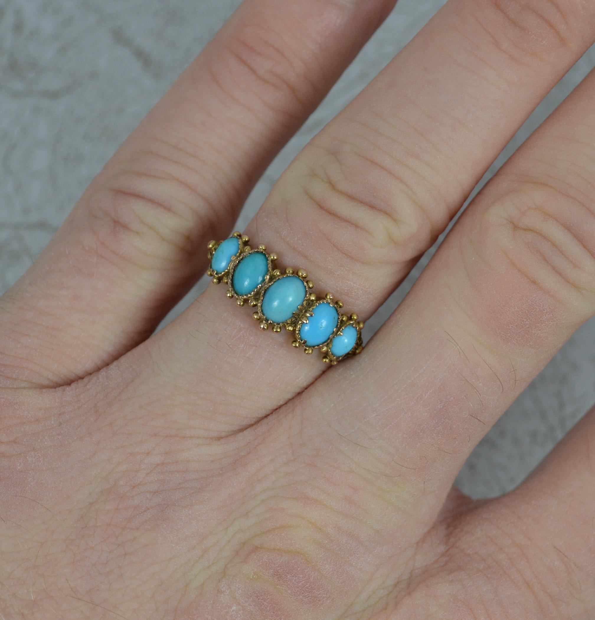 A superb Georgian period ring. Circa 1810.
Solid 15 carat yellow gold example.
Designed with five natural turquoise stones. Each of an oval shape. Fine bezel setting with gold beads surrounding and a very fine pattern to the band