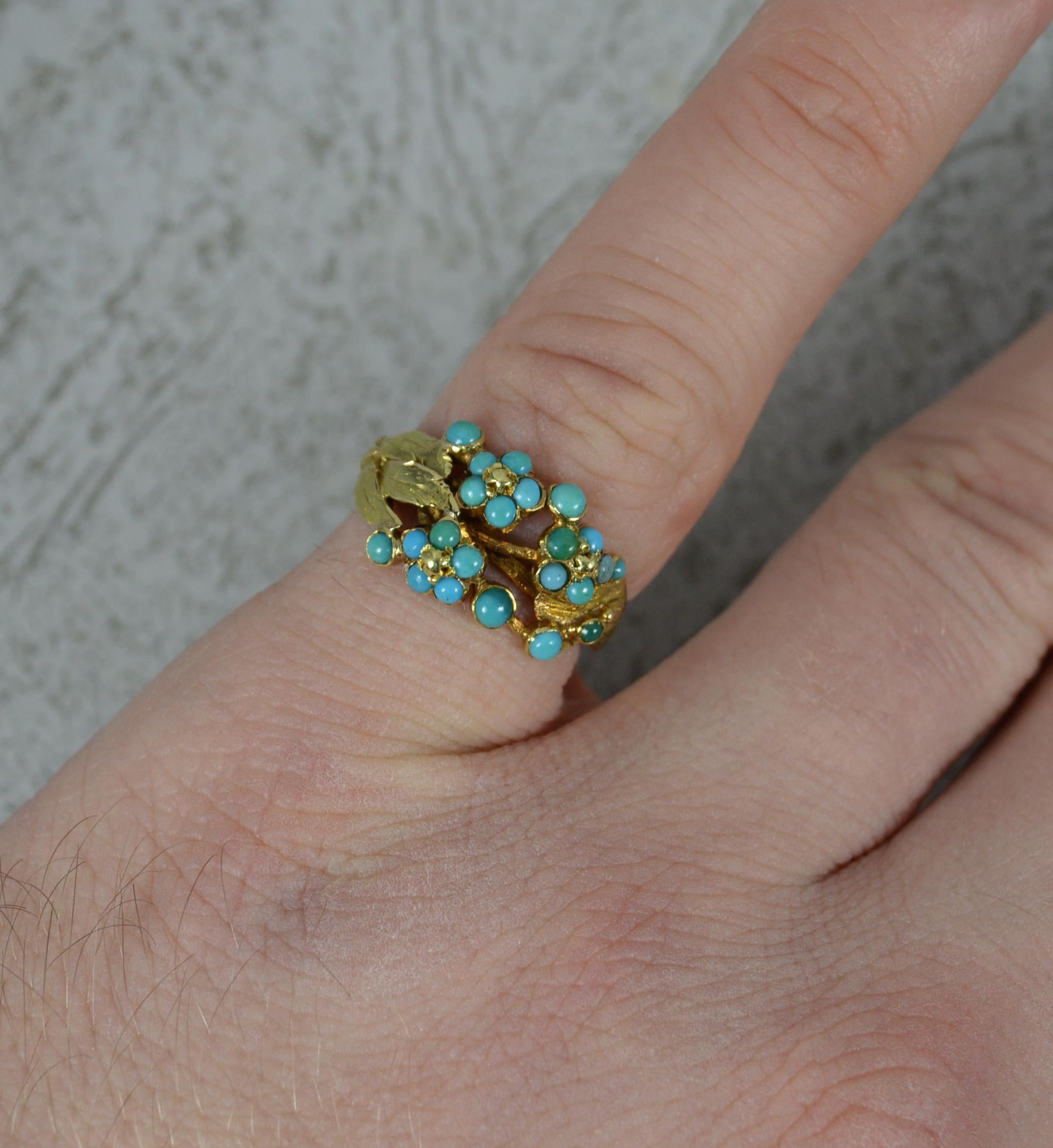 A superb Georgian period ring. Circa 1790.
Solid 15 carat yellow gold example.
Designed with flower head clusters set with small round turquoise cabochons with a band that comprises of leaves and a floral finish.
15mm x 11mm cluster head.