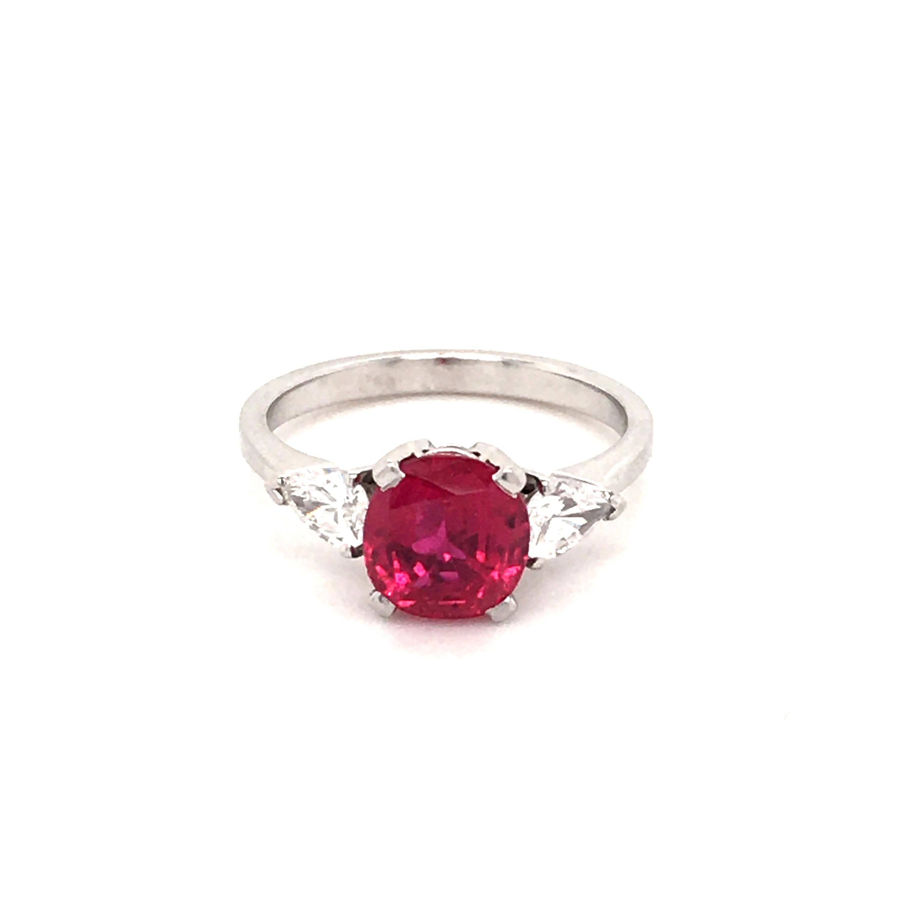 This superb Gubelin ring in platinum features a glowing 2.35 carat cushion-shaped, gem quality, unheated Burmese ruby. Accented by two pear-shaped diamonds of F/G Color and vs clarity, total weight 0.46 carats.

The ruby is accompanied by SSEF