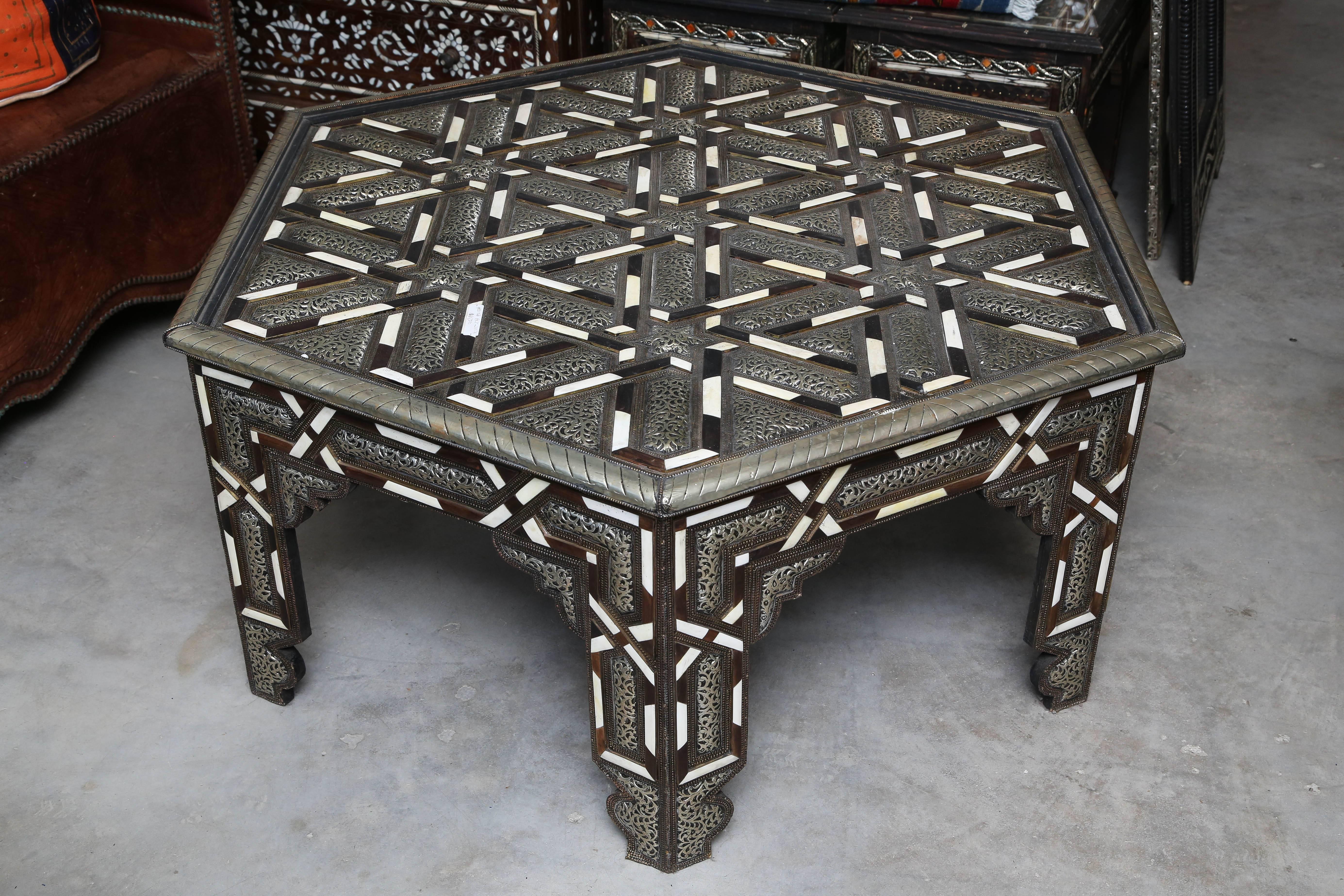 Add an authentic exotic Moroccan and Middle Eastern accent to your home with this hexagon shaped bone, metal and wood inlay coffee table. Beautifully handcrafted in Marrakesh, using traditional craftsmanship and a reference to history.