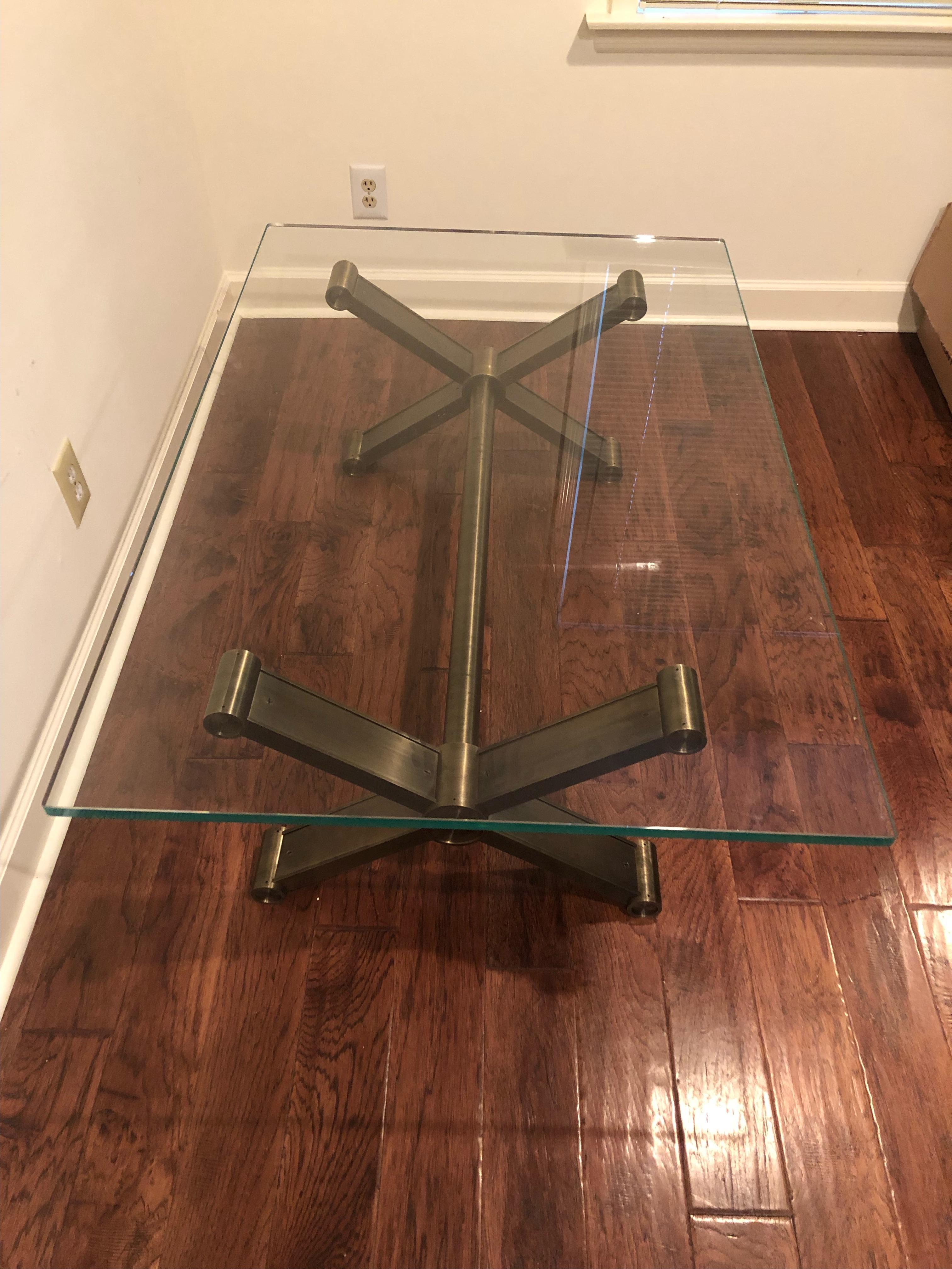 Superb architecturally impressive industrial modern coffee table having heavy weight steel tubular base and .75 thick rectangular glass top. 

 Base is 44 x 23.5.
