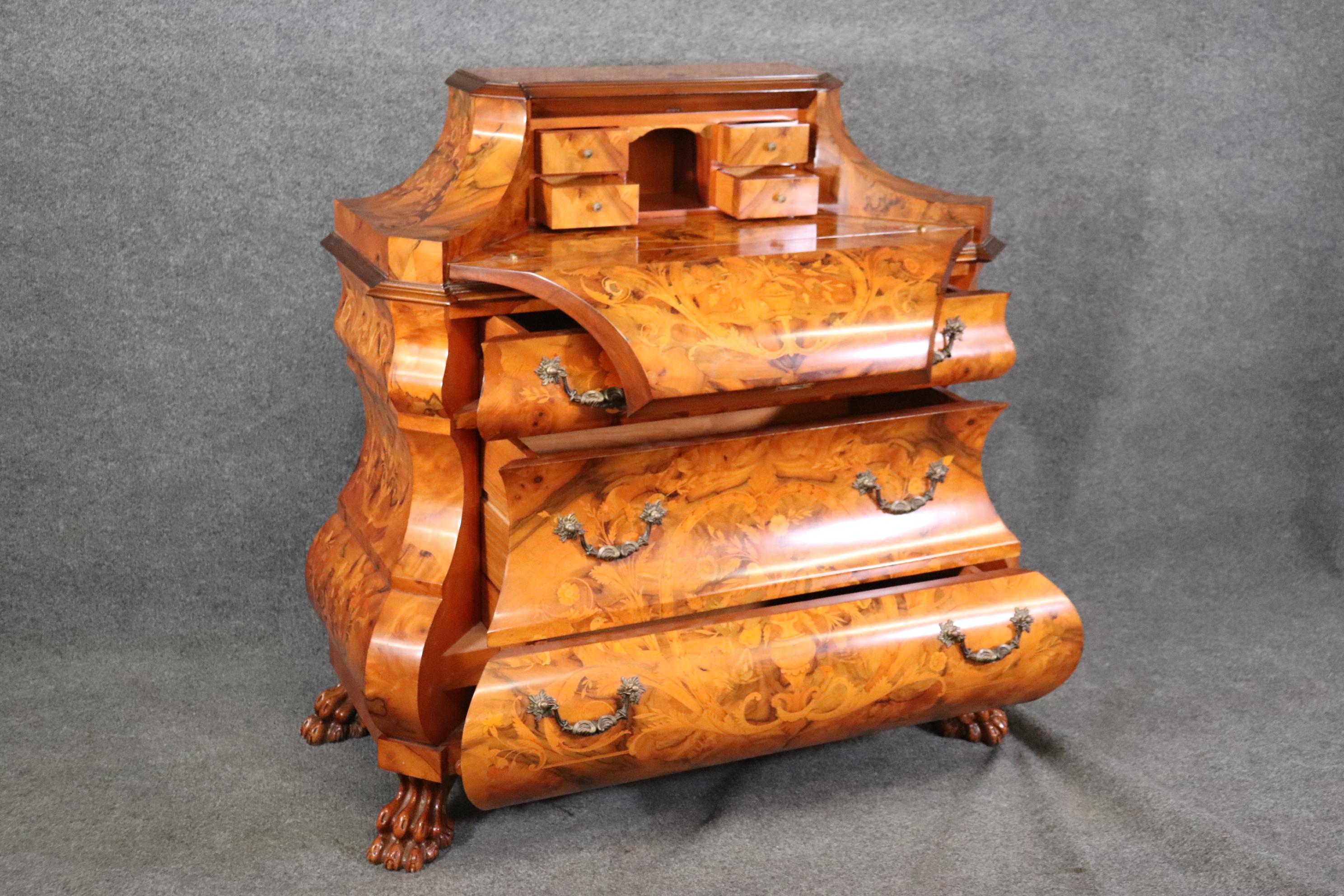 This is a gorgeous Maggiolini of Italy Inlaid to death secretary desk with a fantastic finish and incredible inlay of sparys of flowers in vases and the condition is very good for a used piece. The piece opens up with a curved lid and a key is