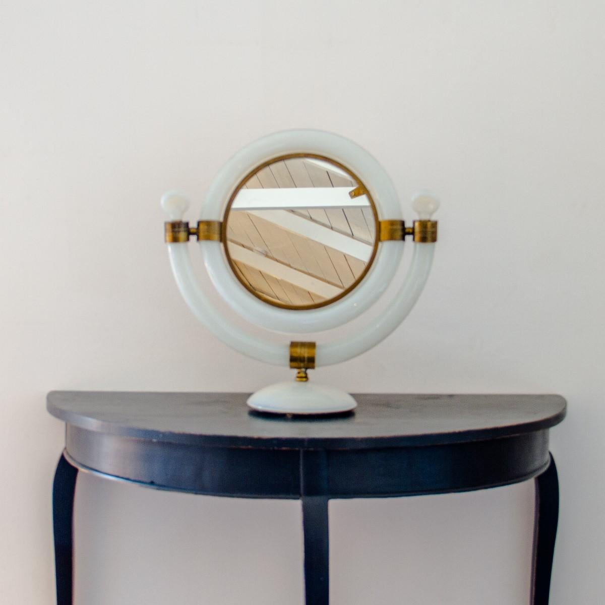 A Superb Italian, white opulescent glass dressing mirror, with brass fixing details and framing the mirror plate, by Seguso, 1950s.

The Seguso family are a historical part of the Murano glass island, trading since 1397. They have one of the
