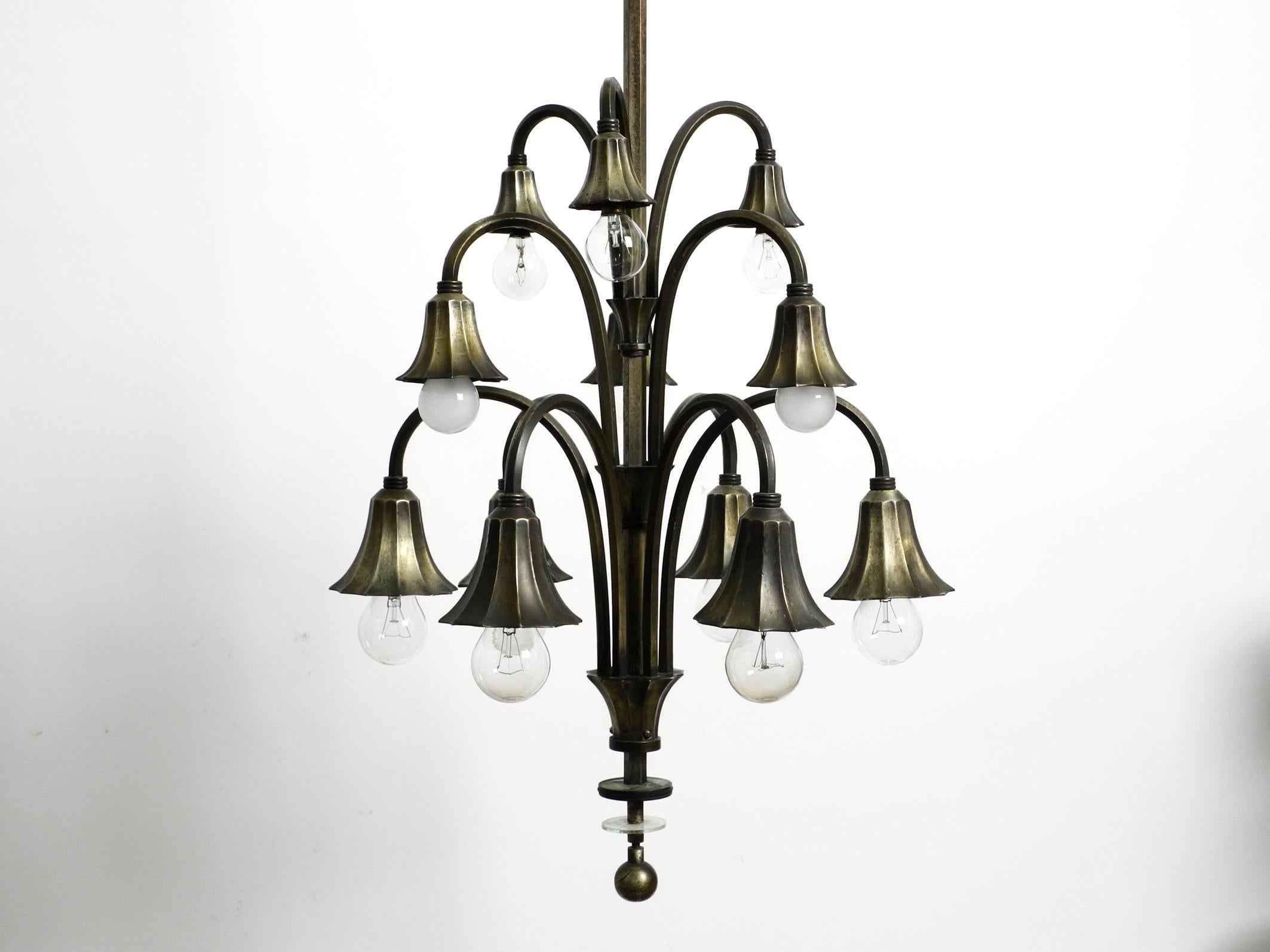 Extraordinary Italian original 1930s silver plated brass 9 socket ceiling lamp.
Beautiful elaborate design with many details.
Entire lamp including rod and canopy are made of heavy brass, and all is silver-plated.
The arms and the rod are made of