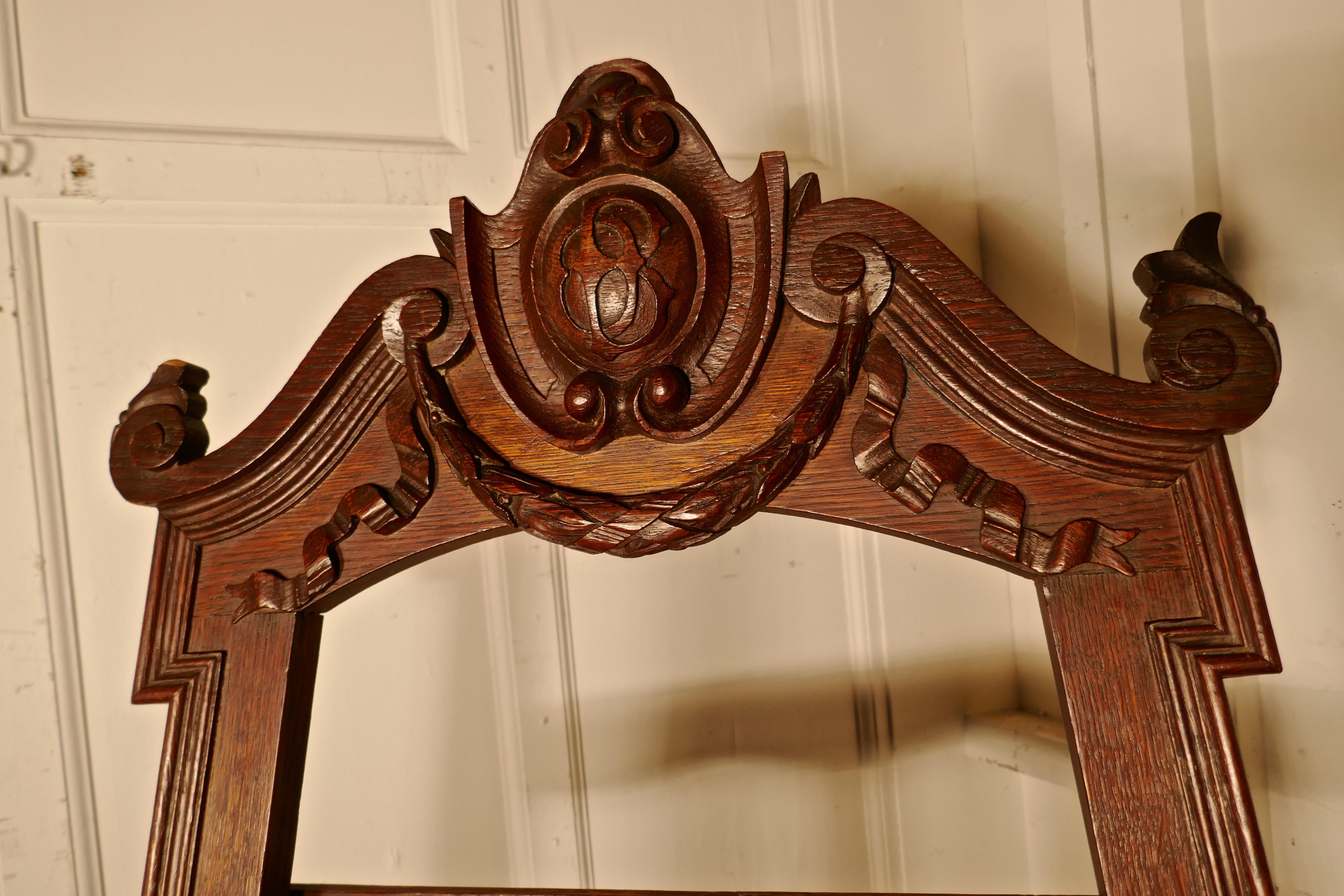 Superb large 19th century carved oak easel.

This is very attractive piece it has a slightly gothic appearance due to the armorial crest at the top
The frame is also decoratively carved on the legs and platform
The easel is in good around