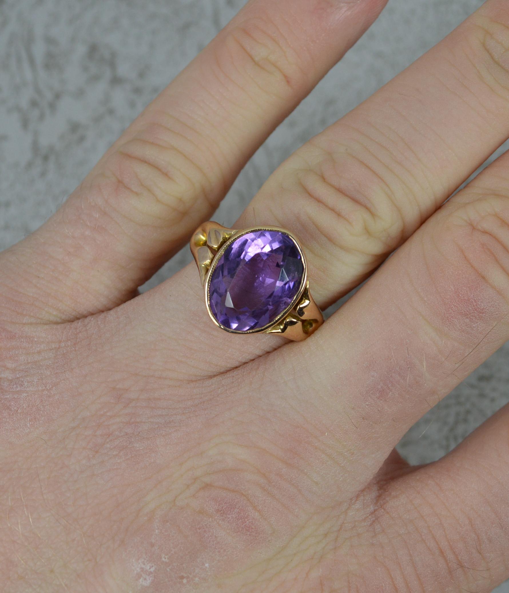 One very simple and stylish ring.
Solid 14 carat yellow gold example.
Set with a single oval cut amethyst in full bezel head. 10mm x 14mm amethyst.

Condition; Very good. Crisp design. Securely set stone, issue free. A lovely ring. Please view