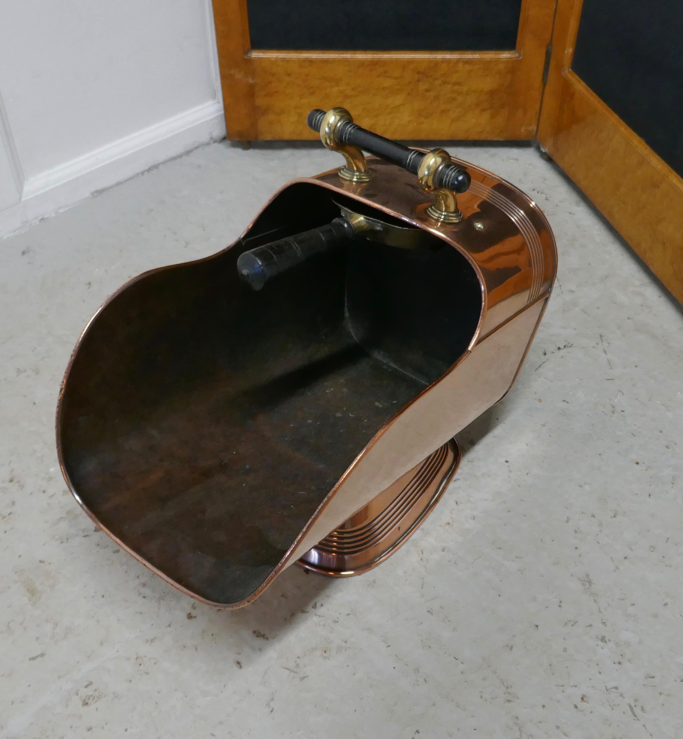 Superb large Arts & Crafts copper helmet coal scuttle

This very top quality piece has good shape, and a broad base foot, it comes with its own brass shovel which is kept inside 

The scuttle is in good condition polished and ready to use, it