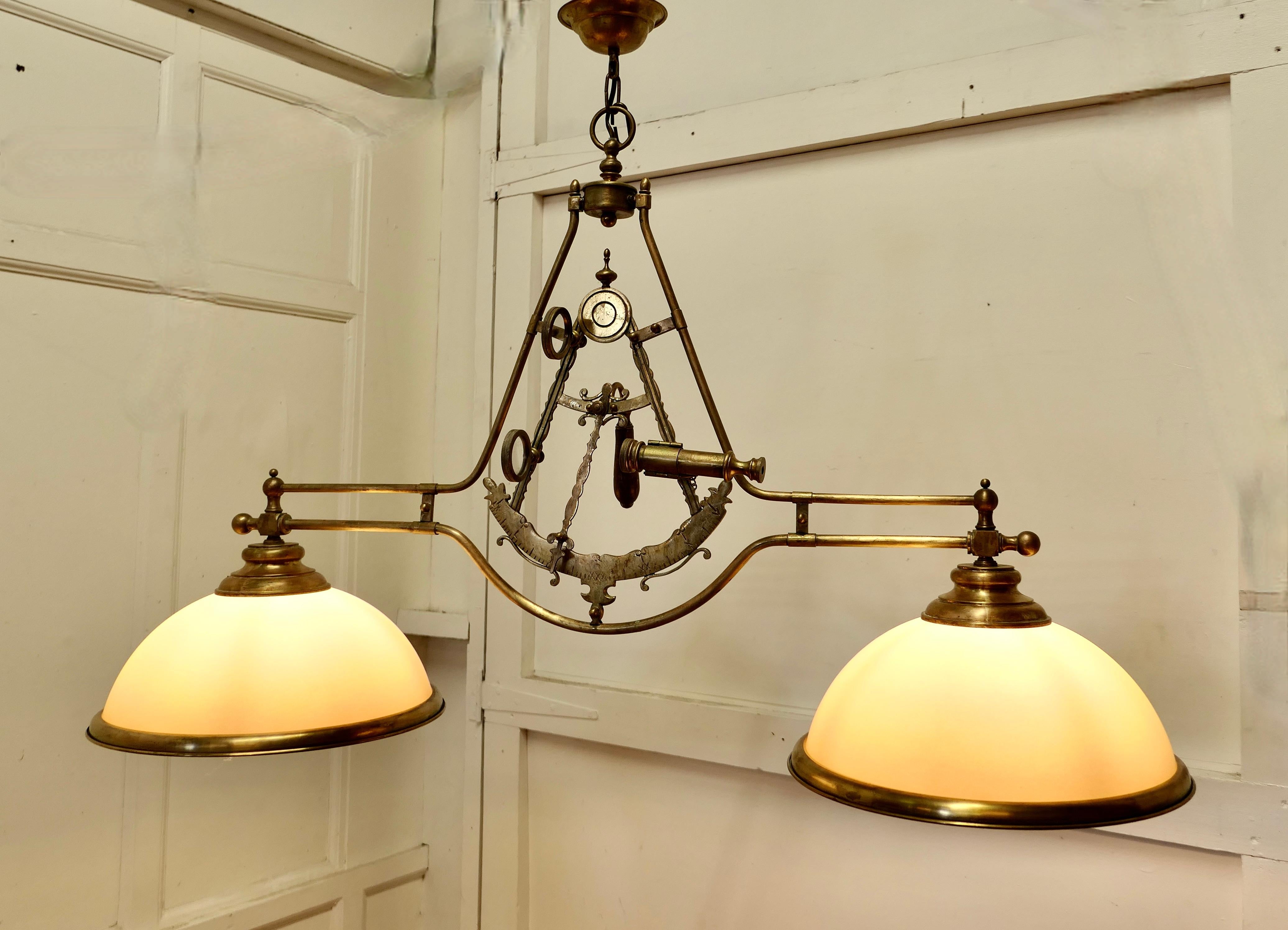 Superb large brass sextant ceiling light from the captains cabin

A very good quality lamp it has been made in the form of a brass sextant, it is centrally hung with a large shade at each end (like a snooker table light)
The lamps each have a