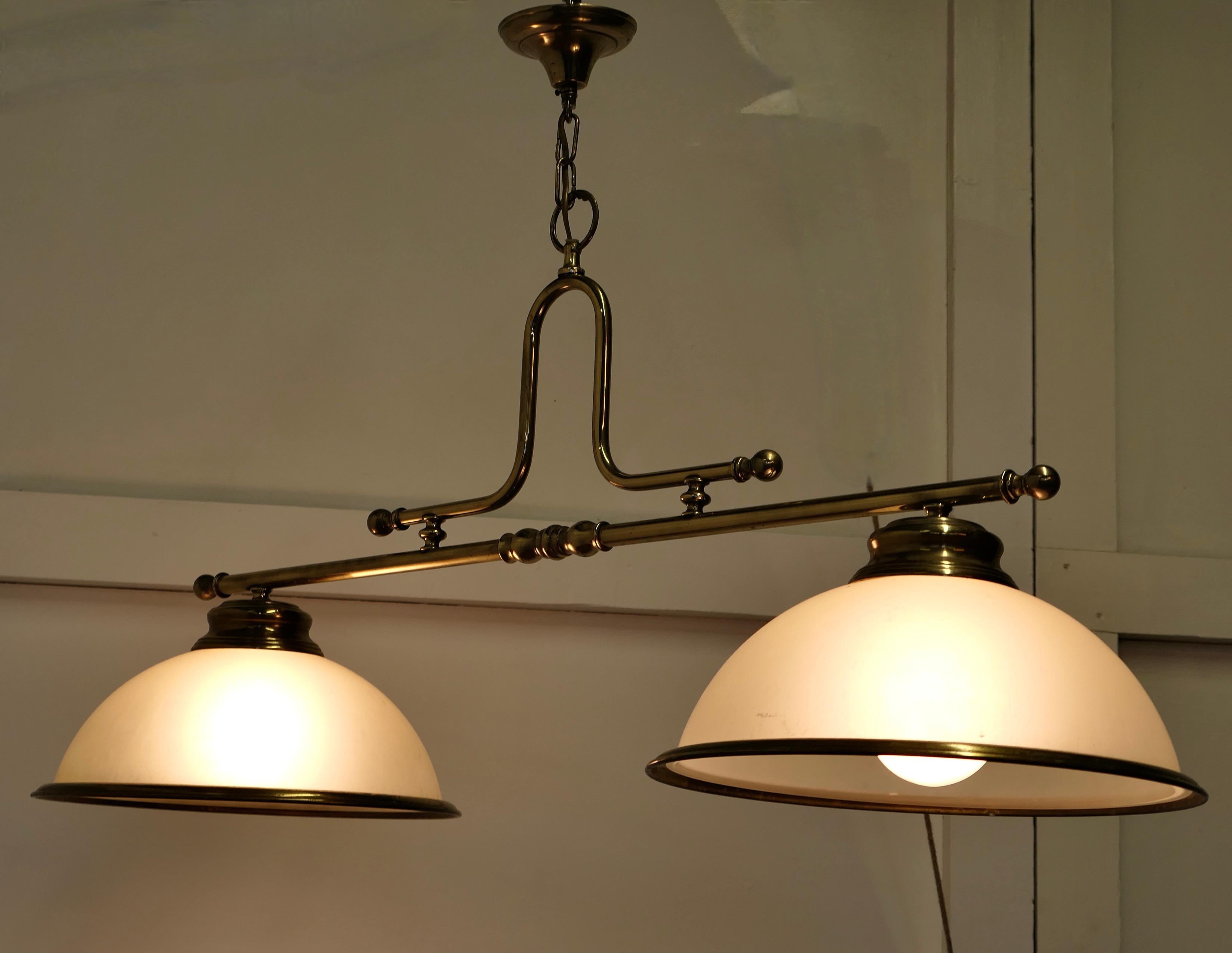 Superb Large Brass Twin Ceiling Light 

A very good quality lamp it is a similar style to a snooker table light 
The twin lamps each have a large heavy opalescent glass shade with a brass rim, The light is in good condition and all working
It is