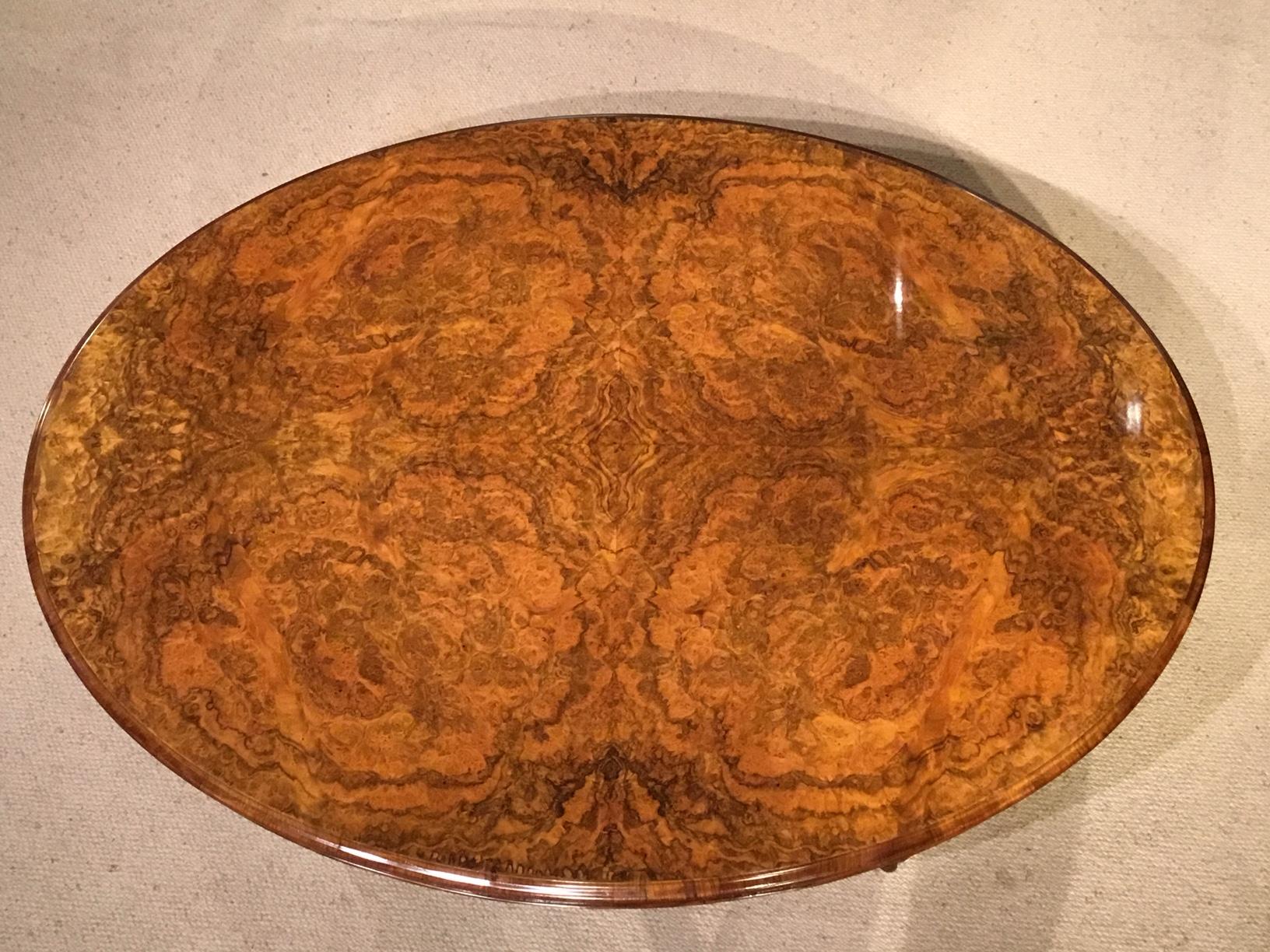 A superb large burr walnut Victorian period coffee table. Having an oval top veneered in the finest burr walnut with a beautiful colour and finish. With a walnut moulded edge, burr walnut frieze and supported on four turned and finely carved column