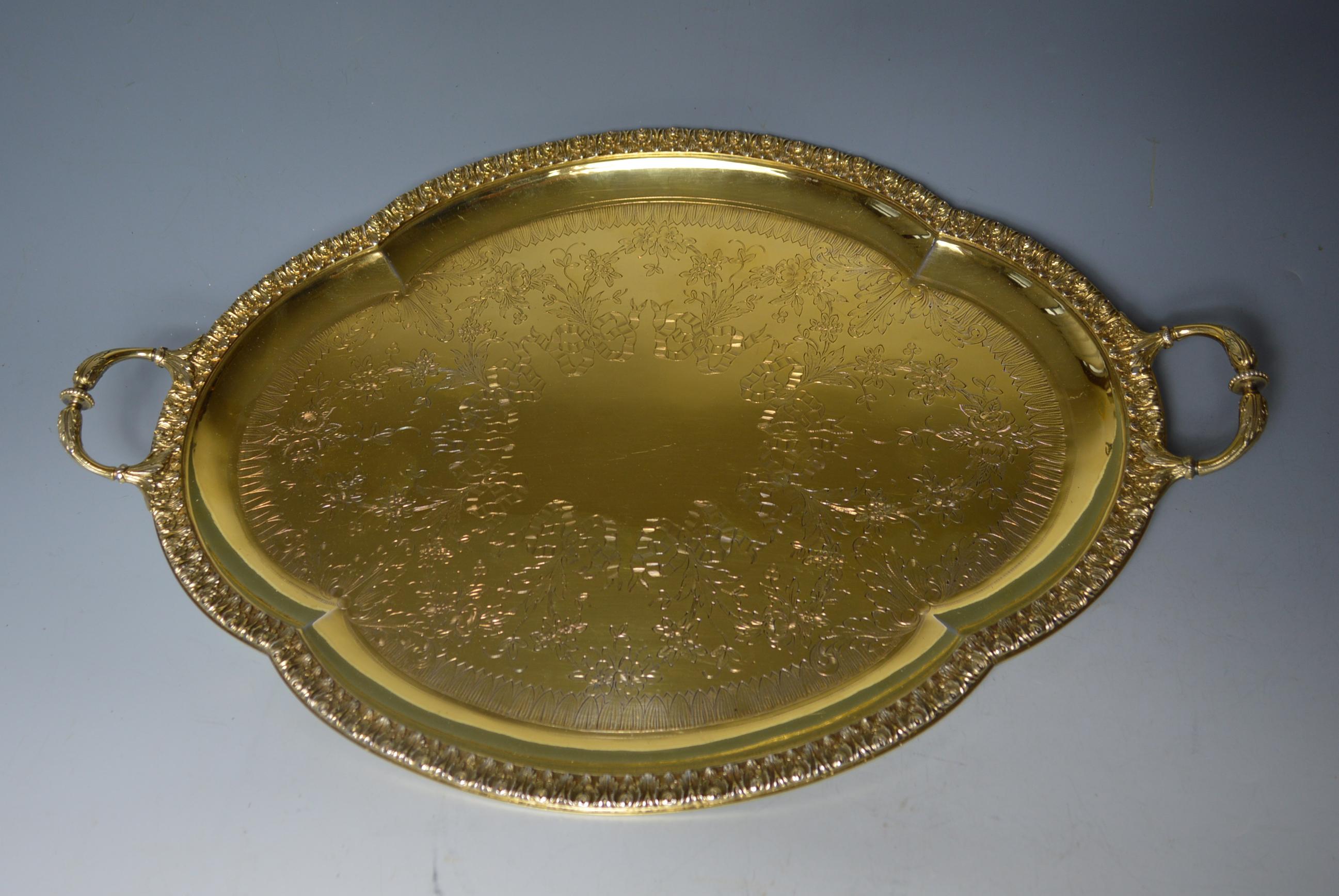 Superb large French two handled silver gilt serving tray Leon Lapar Paris

The large tray modeled with four lobes the edge engraved with floral branches and chiseled acanthus leaves
with flowering branches and wrapped knots

Measures: Length 54