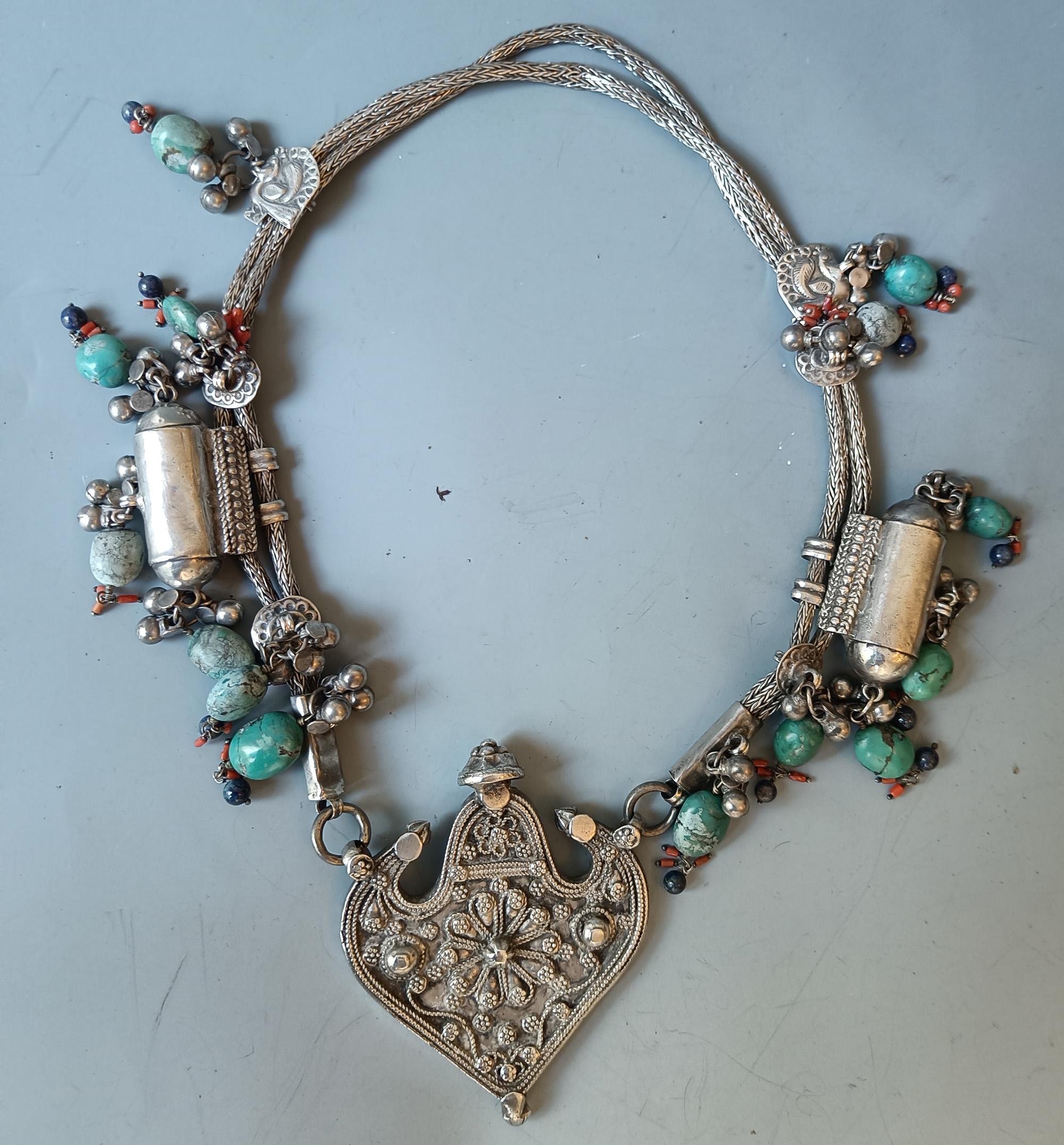 A superb large Indian Tribal silver necklace from the Gujarat region with large ornate central silver medallion with turquoise and coral beads
 
 

Weight 400 grams