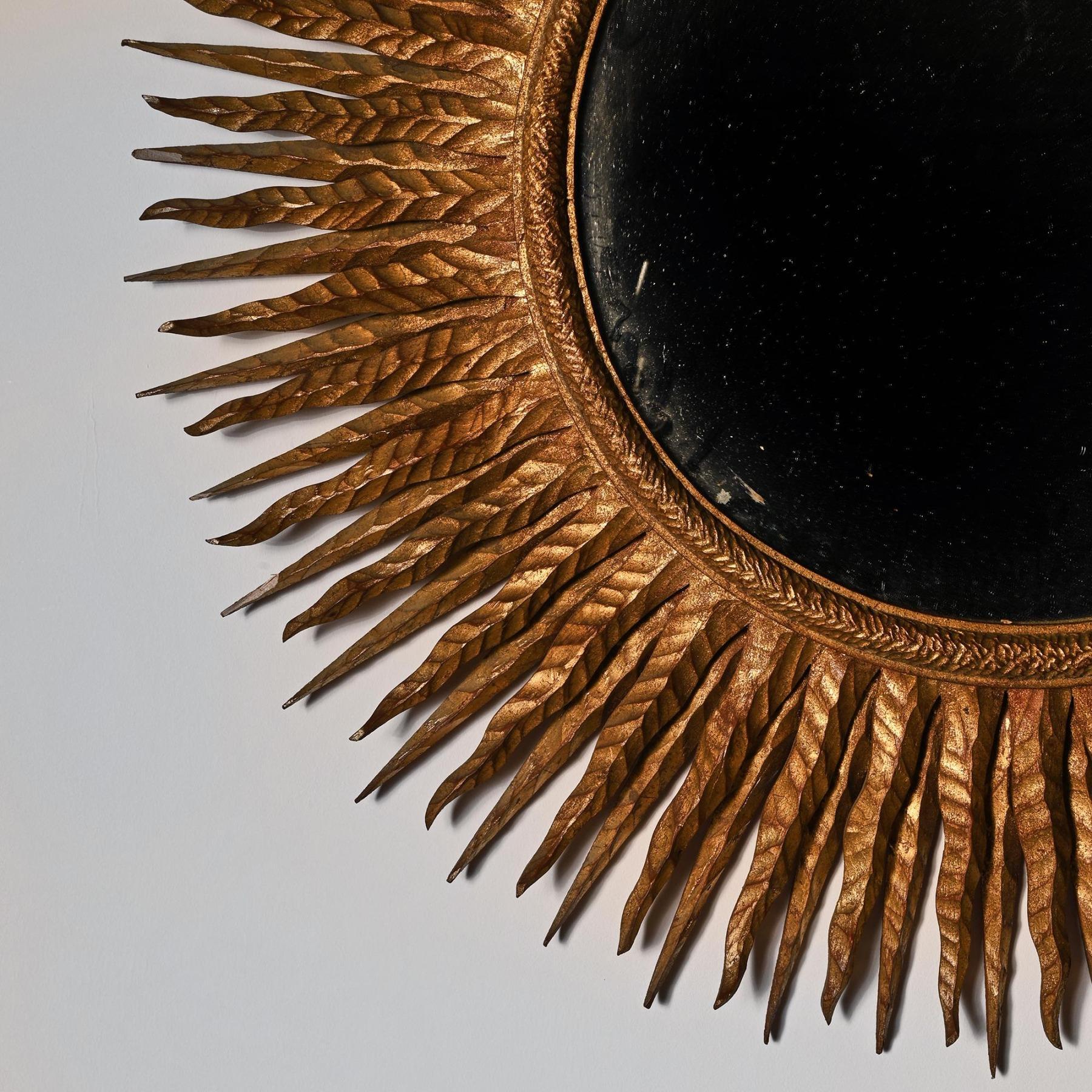 A superb and rare mid-20th century French gilt wood sunburst mirror.

France, circa 1950.

Extremely well designed carved giltwood sunburst mirror having two differing stylized tiers radiating outwards with a carved inter circle. One of the best
