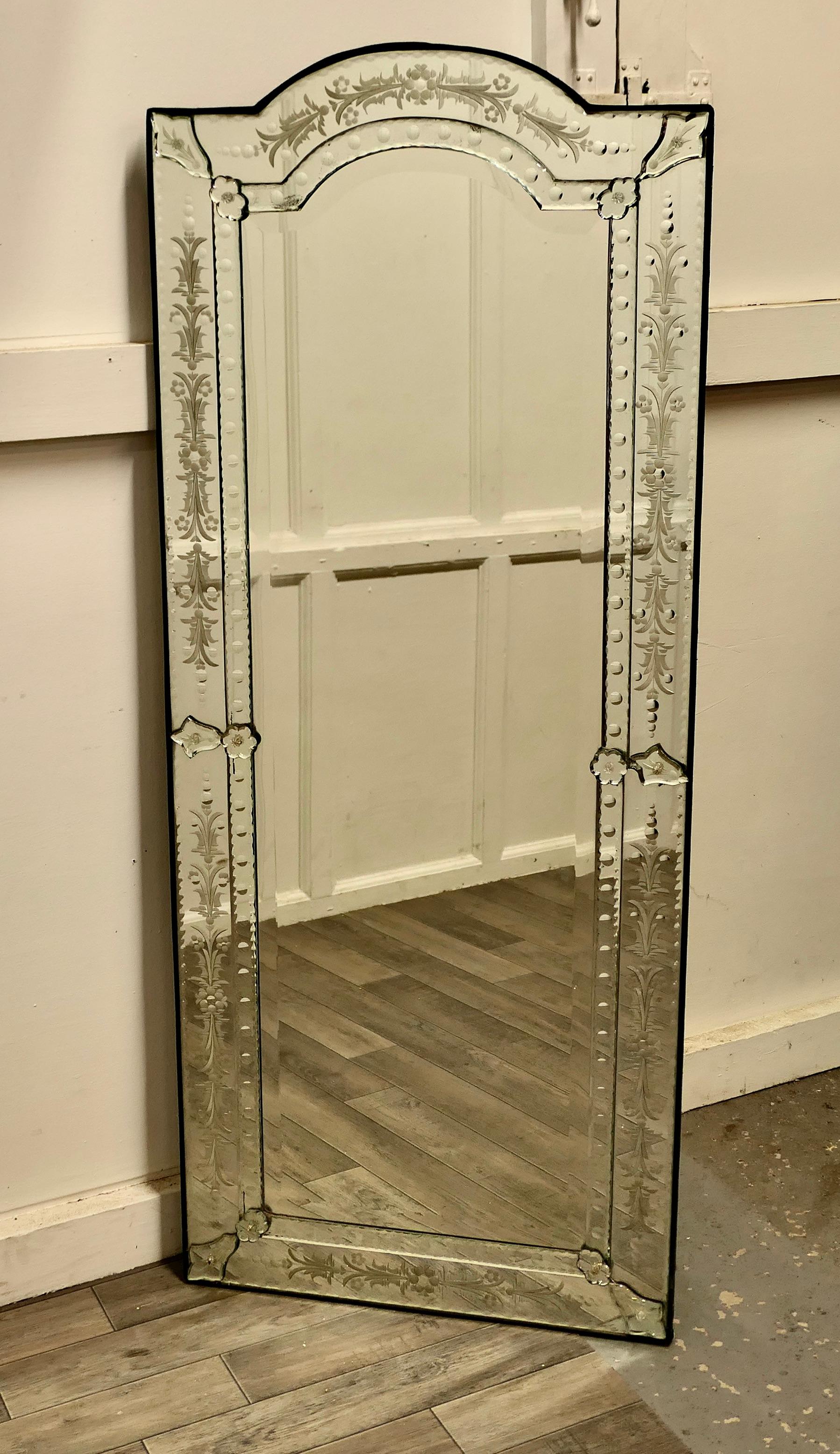 Superb large venetian pier mirror.

This is the most outstanding piece, there are no repairs or damage, the mirror is full length with a slightly arched top and a reverse etched floral decorated theme all round on the 3” wide border.
The mirror