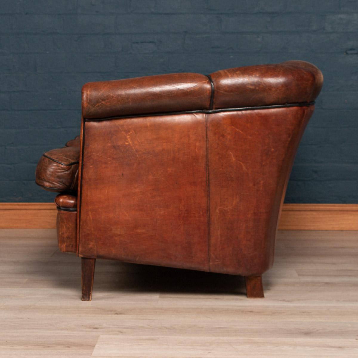 A very elegant scallop back two-seat sheepskin leather sofa, mid-late 20th century, manufactured in Holland and of the finest quality with great patina.

Please note that our interior pieces are located at our Interior Design Showroom in