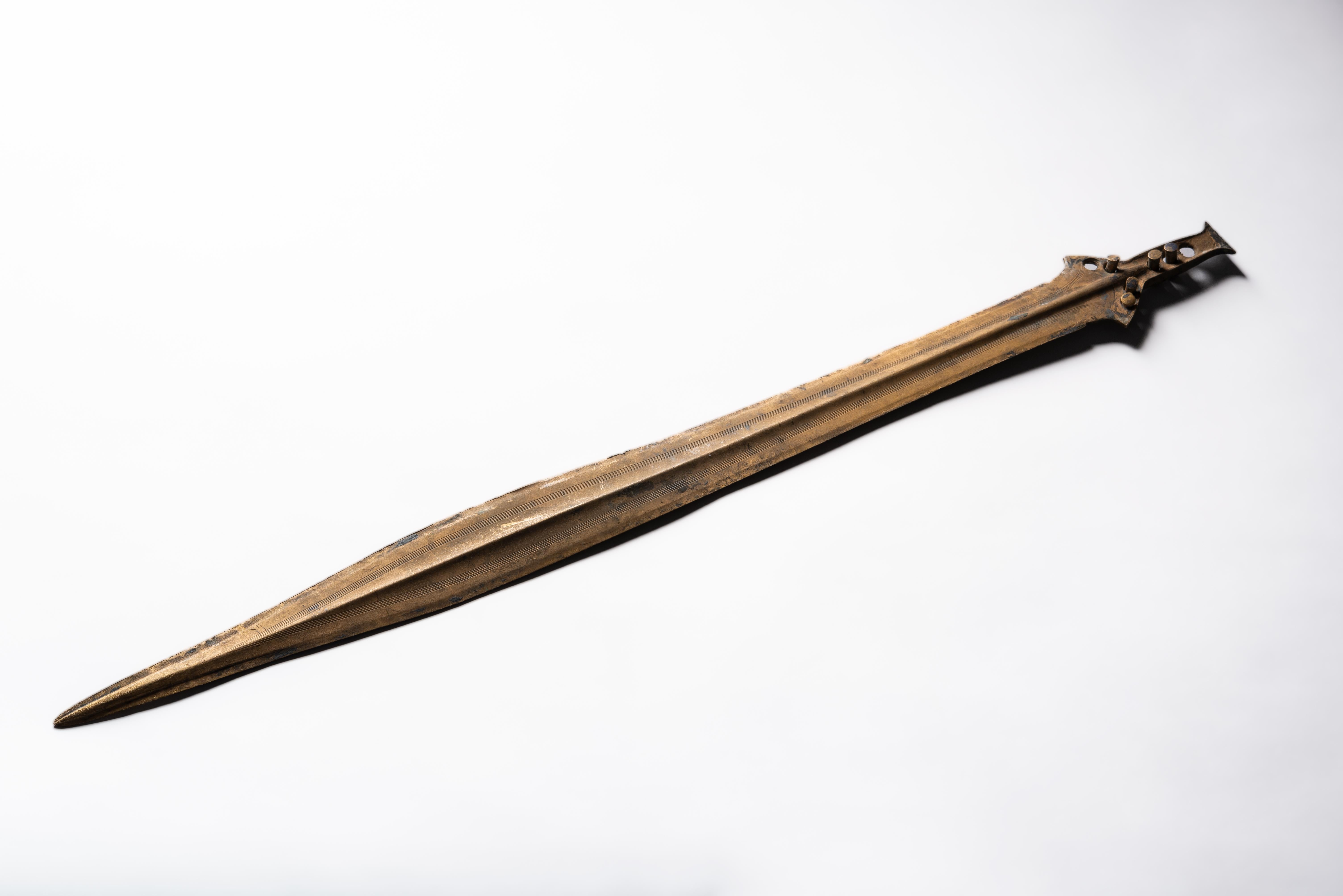 Saint Nazaire Sword, Late Bronze Age, circa 800-900 B.C.

An exceptionally well preserved Bronze Age sword, with elegant, finely incised decorations, near perfect form and a wonderful, golden patina. Subtly leaf shaped and tapering to a fine