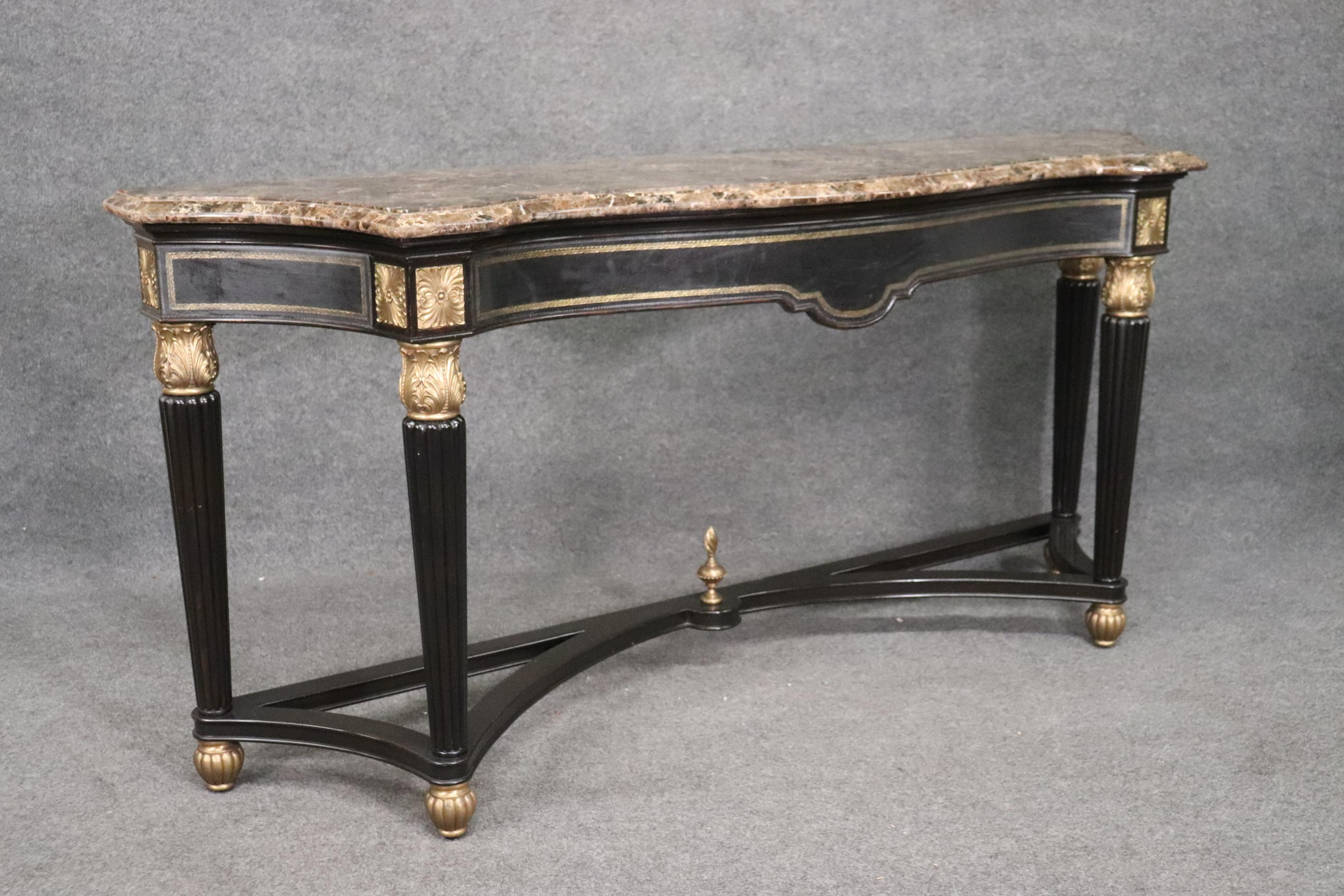 This is a gorgeous console table witrh fantastic quality bronze ormolu and a great slab of marble on top. The ebonized frame of the table is in good condition as is the rest of the table. The table measures 78 wide x 20 deep x 36 tall and dates to