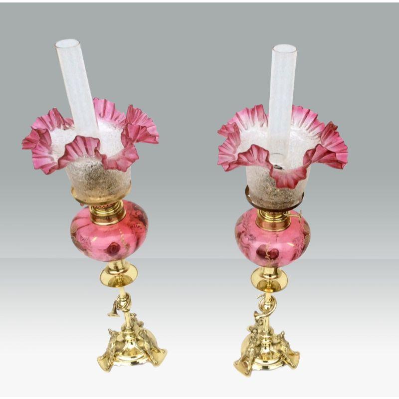 Superb Matching Pair Of Original Antique Ruby Glass Oil Peg Lamps With Hunting Theme, (Brass Pillers Mounted With Three Dogs And Hunting Horn Bugle) 

Circa 1880. 
20ins to top of Funnels. 
Shades 6ins diameter. 
 
Declaration: This item is